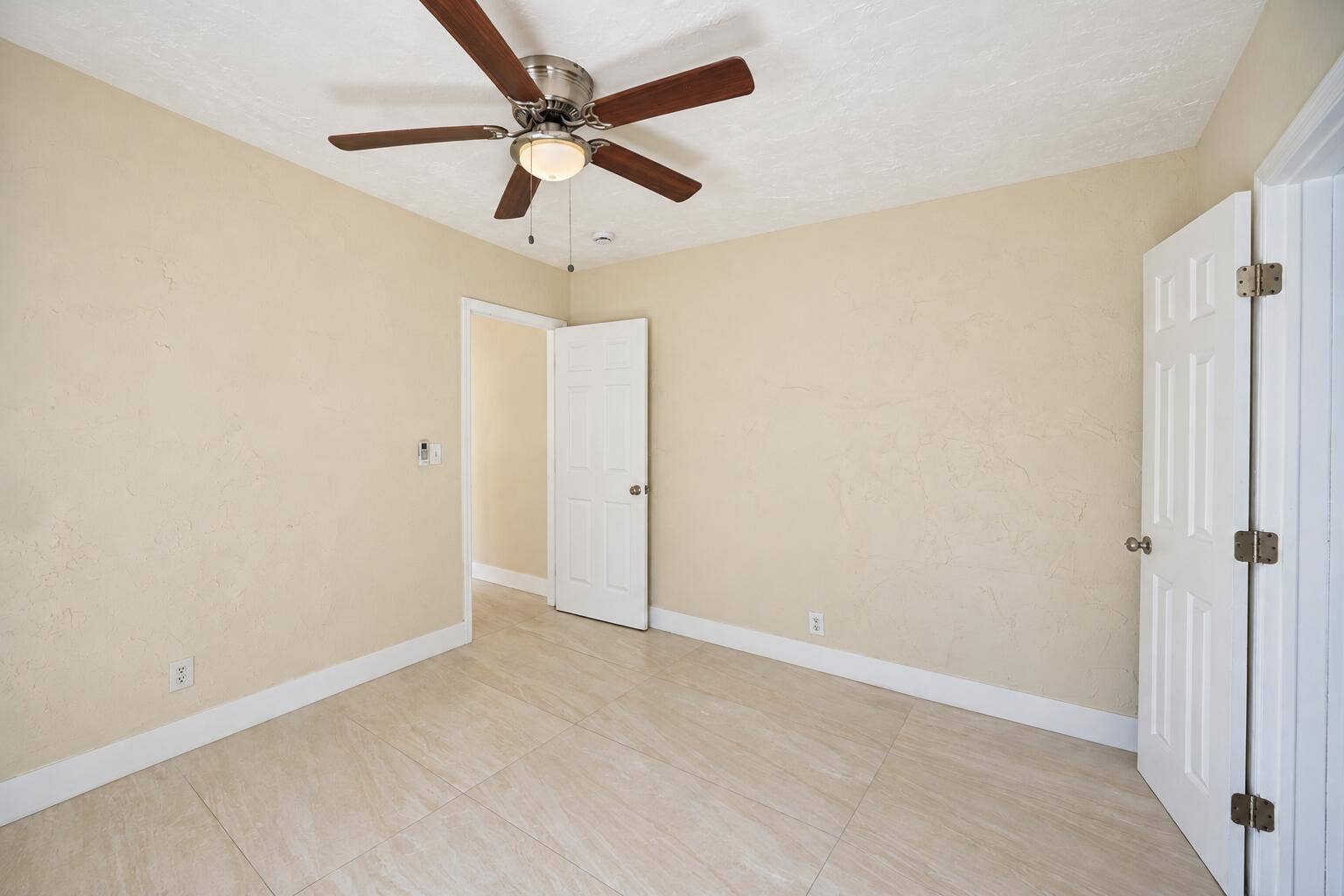 Bright Empty Beige Room with Ceiling Fan