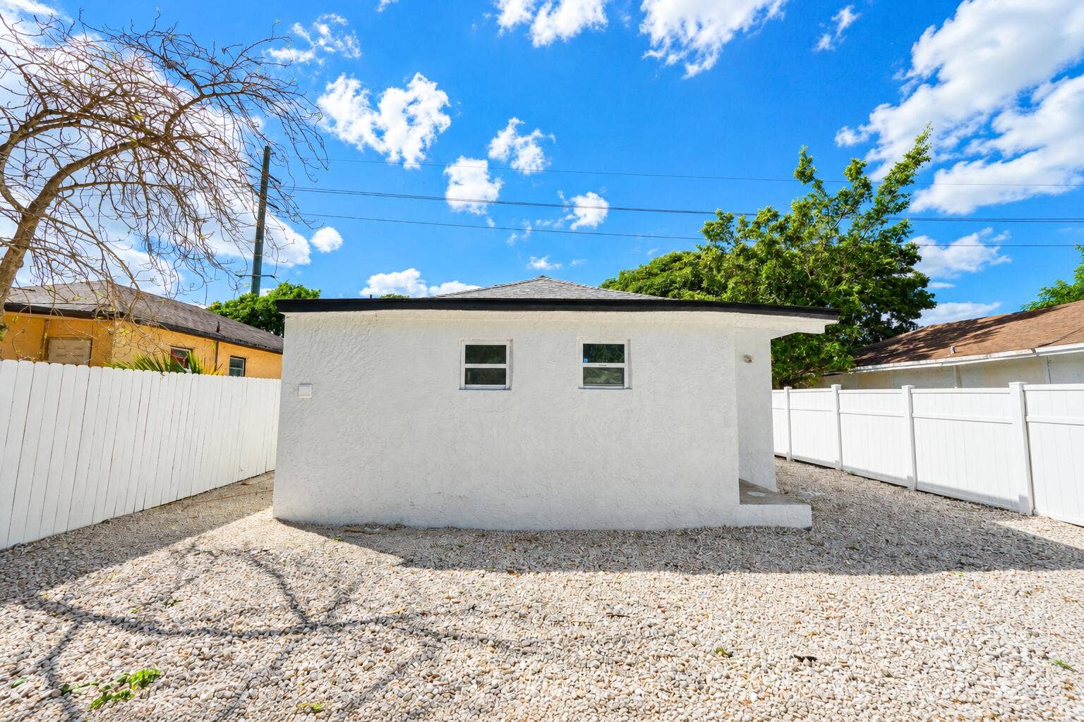 Bright Stucco Backyard Under Blue Skies