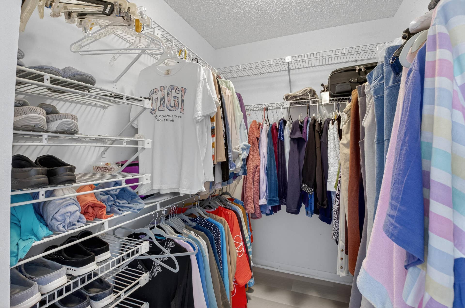 1 of 2 walk in closets in primary bedroom