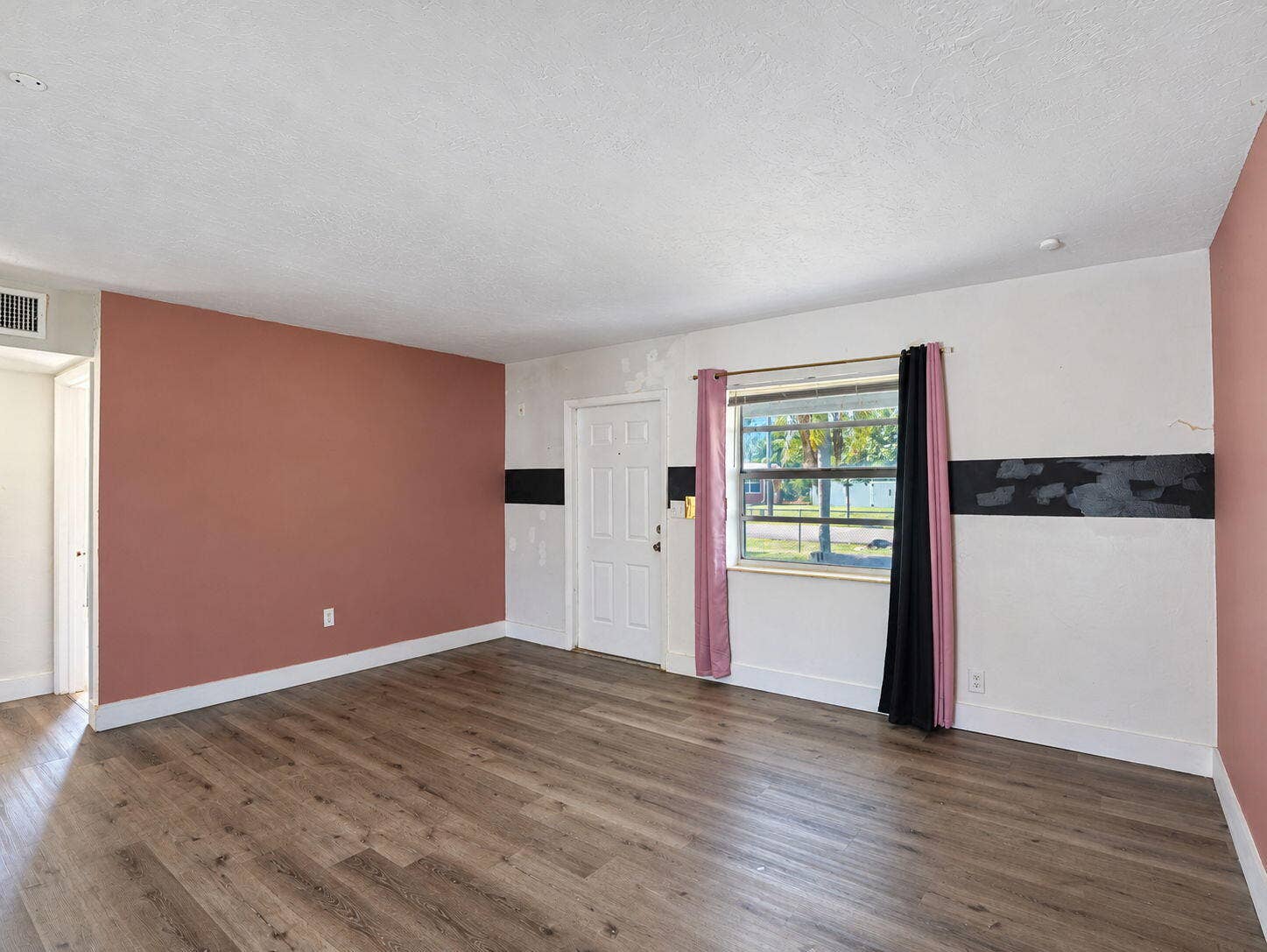 1805 NW 13TH Court, Fort Lauderdale, FL 33311 Living Room featuring wood-finish flooring, floor-to-ceiling mirrored wall paneling