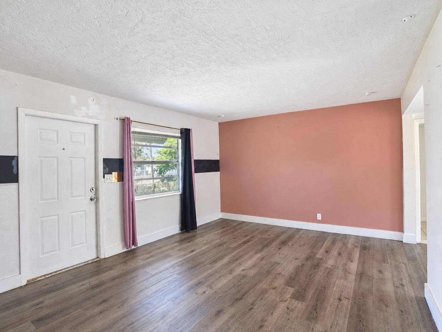1805 NW 13TH Court, Fort Lauderdale, FL 33311 Entry/living room wood-finish flooring, with an accent wall,