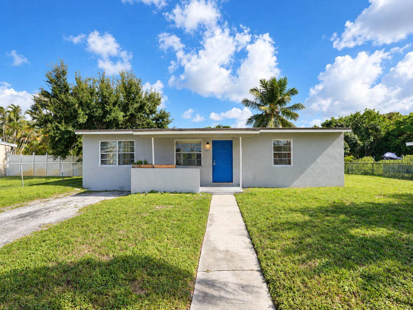 1805 NW 13TH Court, Fort Lauderdale, FL 33311 Single-story exterior featuring a concrete walkway, covered entryway
