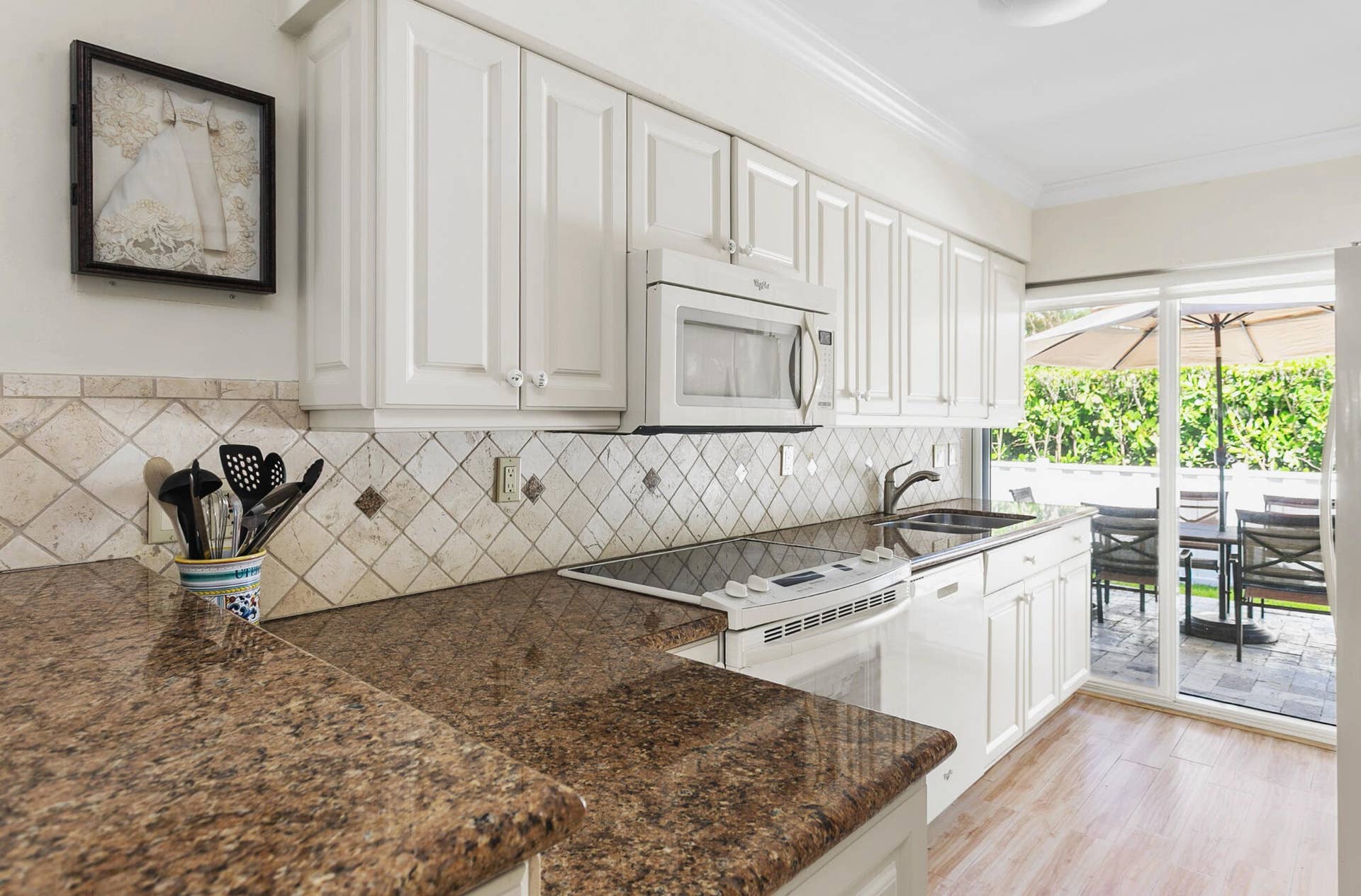 2607 SE 21ST Street, Fort Lauderdale, FL 33316 Light filled kitchen featuring sliding glass doors to outside patio and entertainment area