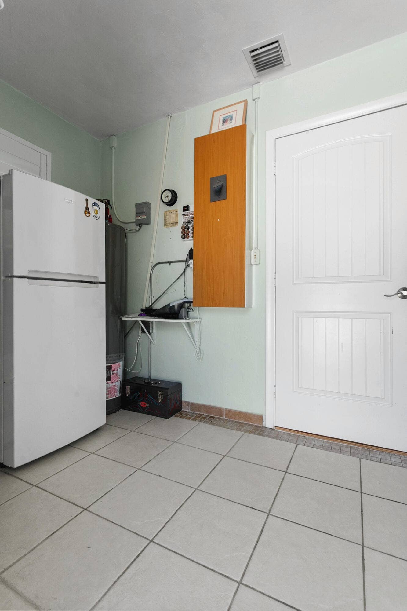 2607 SE 21ST Street, Fort Lauderdale, FL 33316 Utility area featuring washer, dryer, shelving, extra refrigerator and plenty of space for pantry items, ironing board, vaccum cleaner, etc