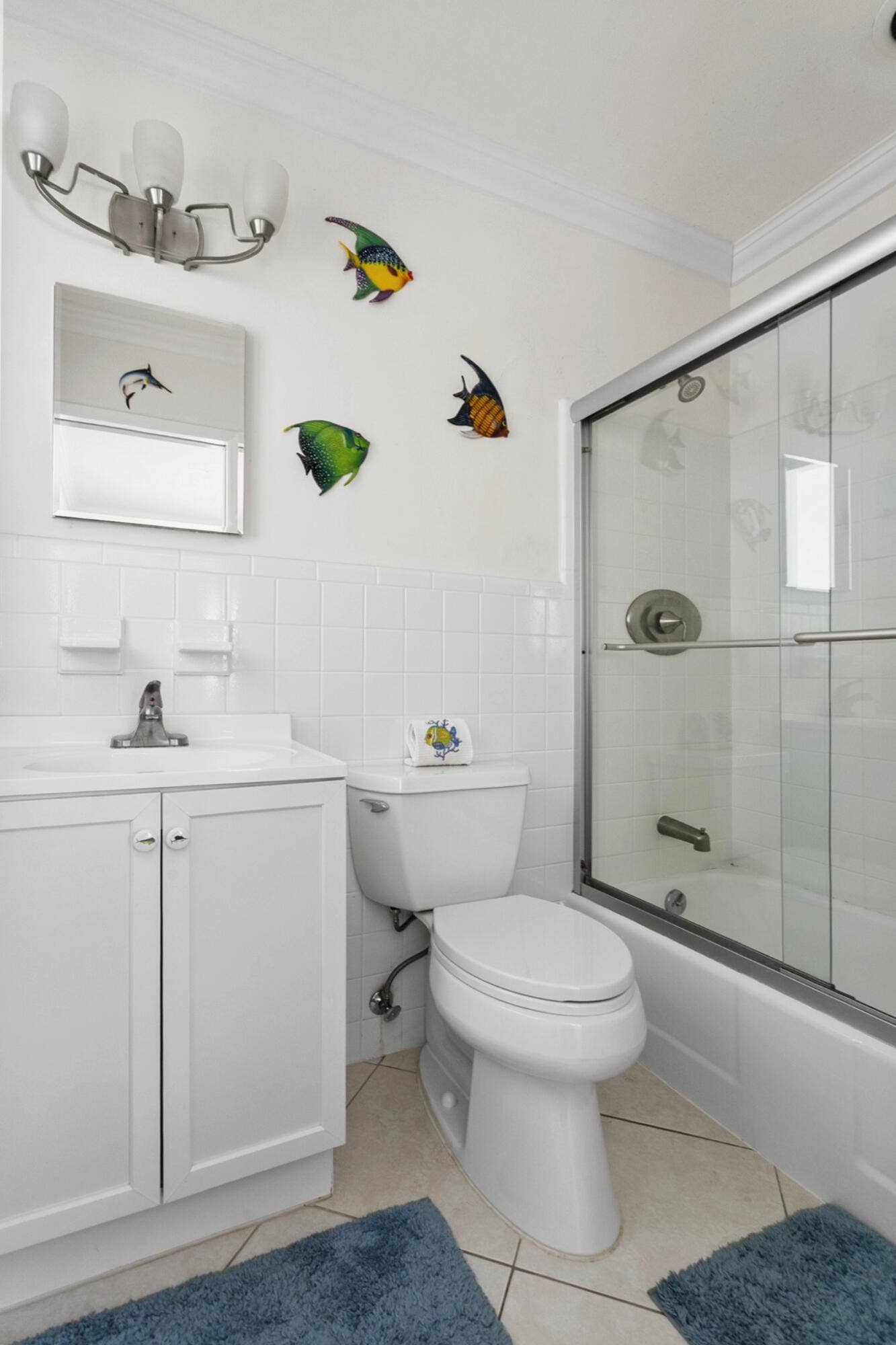 2607 SE 21ST Street, Fort Lauderdale, FL 33316 En-suite Guest Bathroom featuring a white vanity cabinet, square undermount sink, brushed nickel hardware, and a shower-tub combination with sliding glass doors