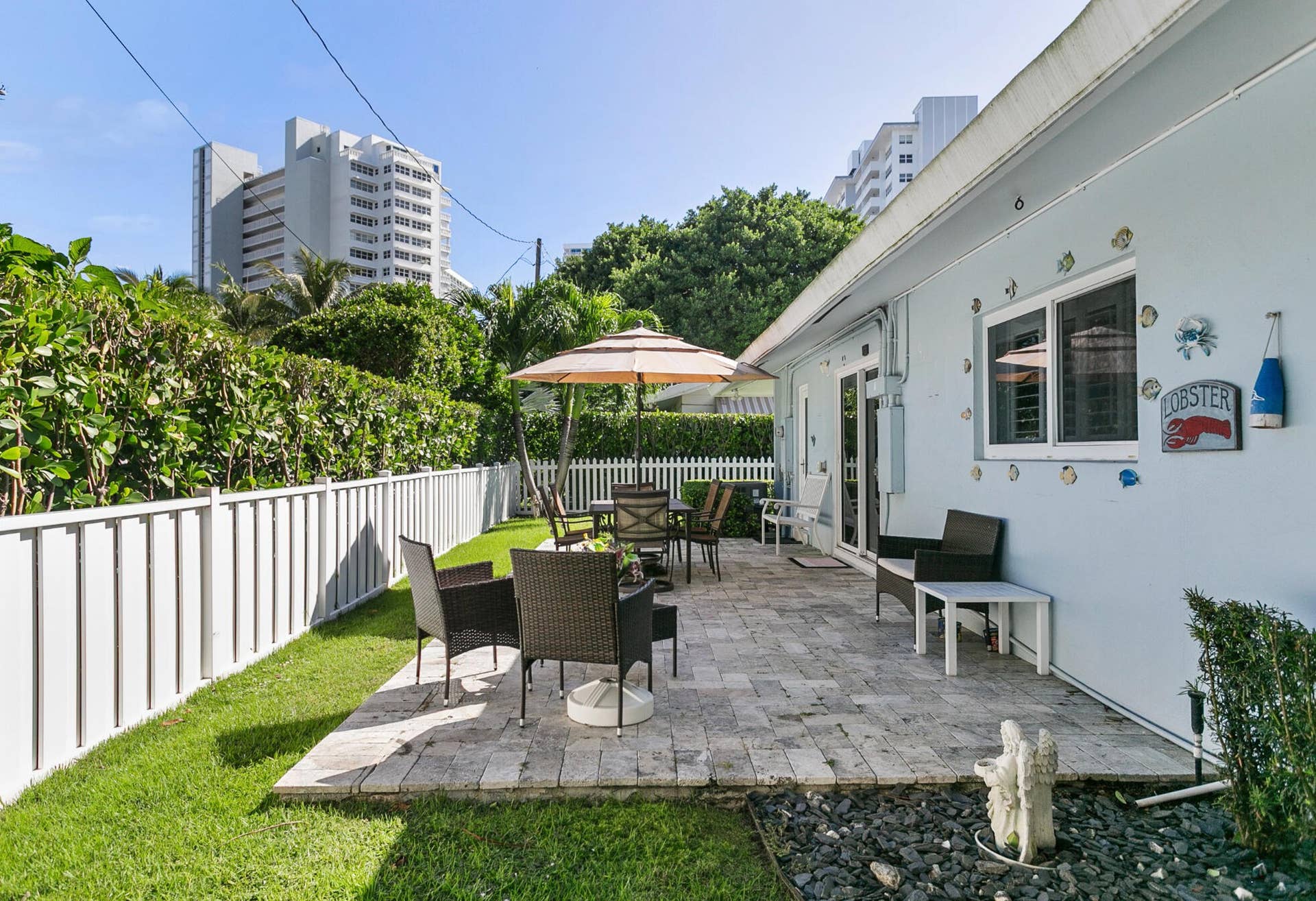 2607 SE 21ST Street, Fort Lauderdale, FL 33316 Rear patio featuring natural stone pavers, green space and bordered by a privacy fence
