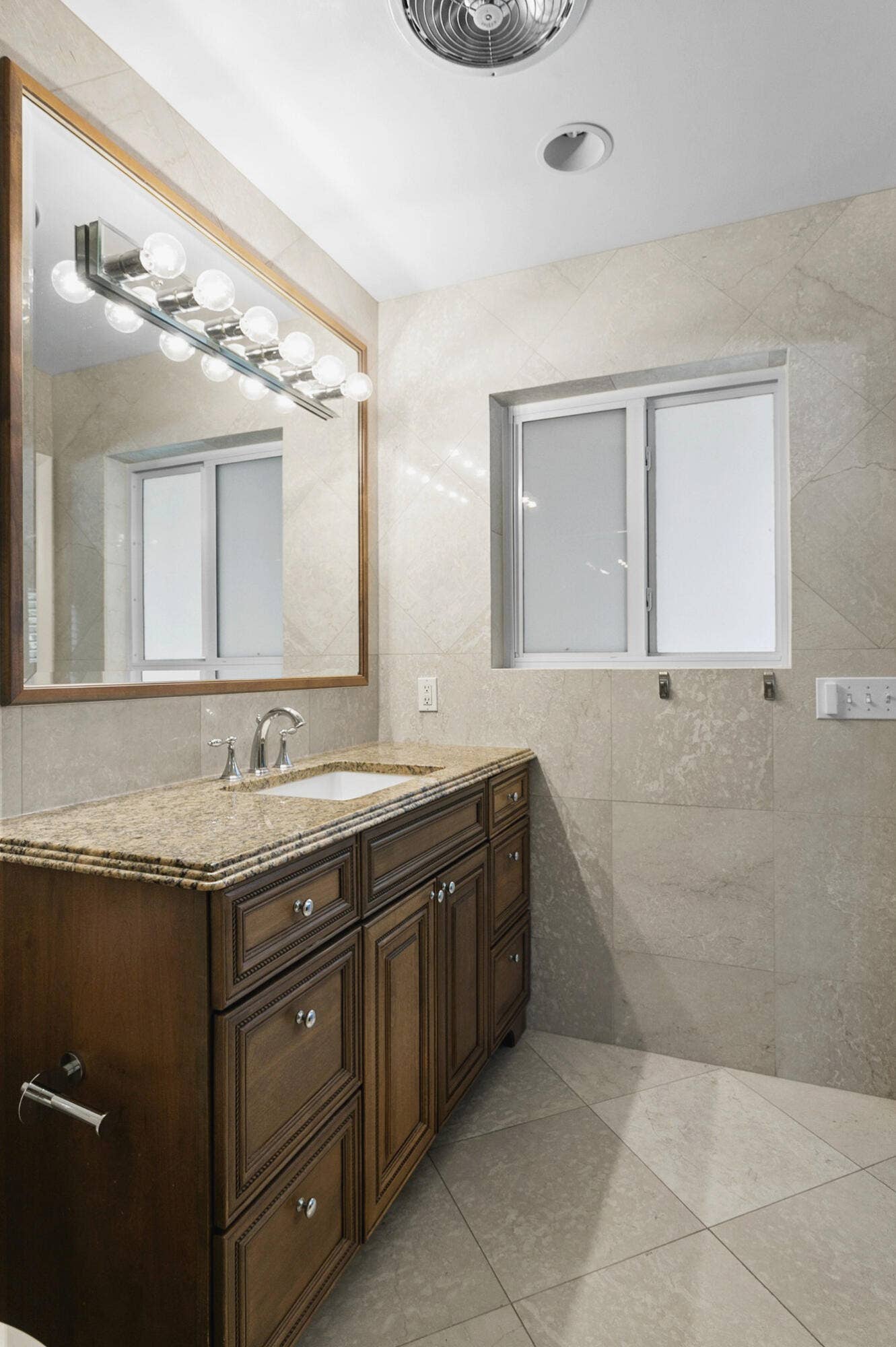 2607 SE 21ST Street, Fort Lauderdale, FL 33316 Master bathroom with Custom wood cabinetry with stone countertop, undermount sink and large walk in shower