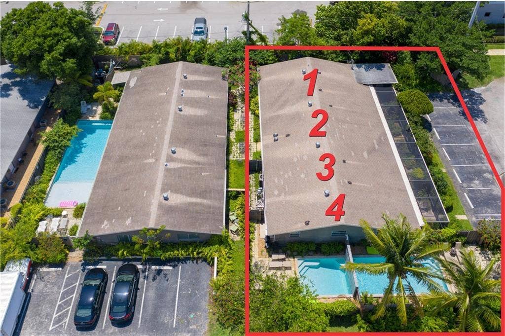2225 NE 14th Avenue, #1, Wilton Manors, FL 33305 Aerial view of building, pools and parking. This is end unit #1.