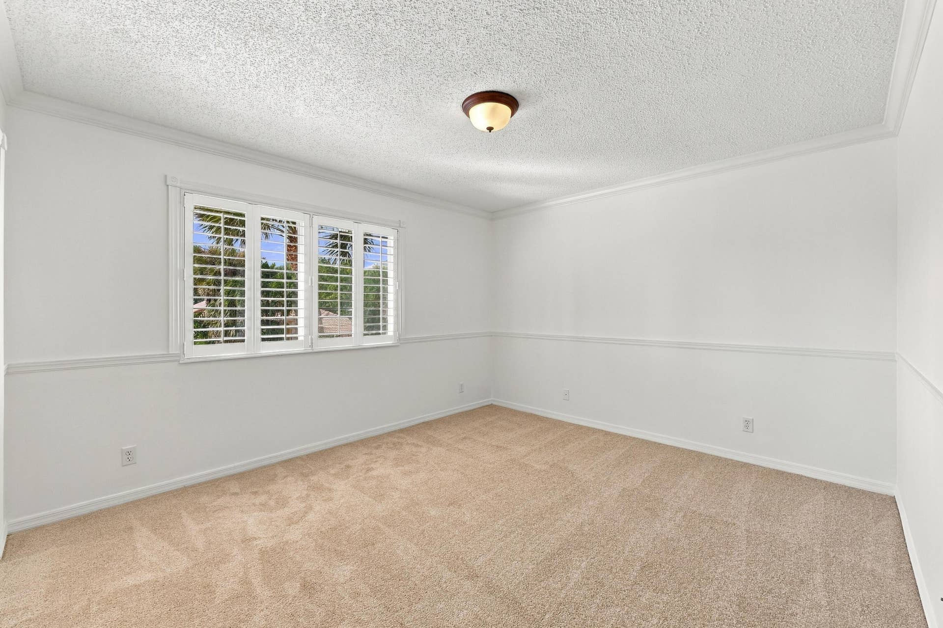 10671 St Thomas Drive, Boca Raton, FL 33498 A generously sized bedroom featuring plush carpeting, neutral finishes, and ample natural light, creating a comfortable and welcoming space.