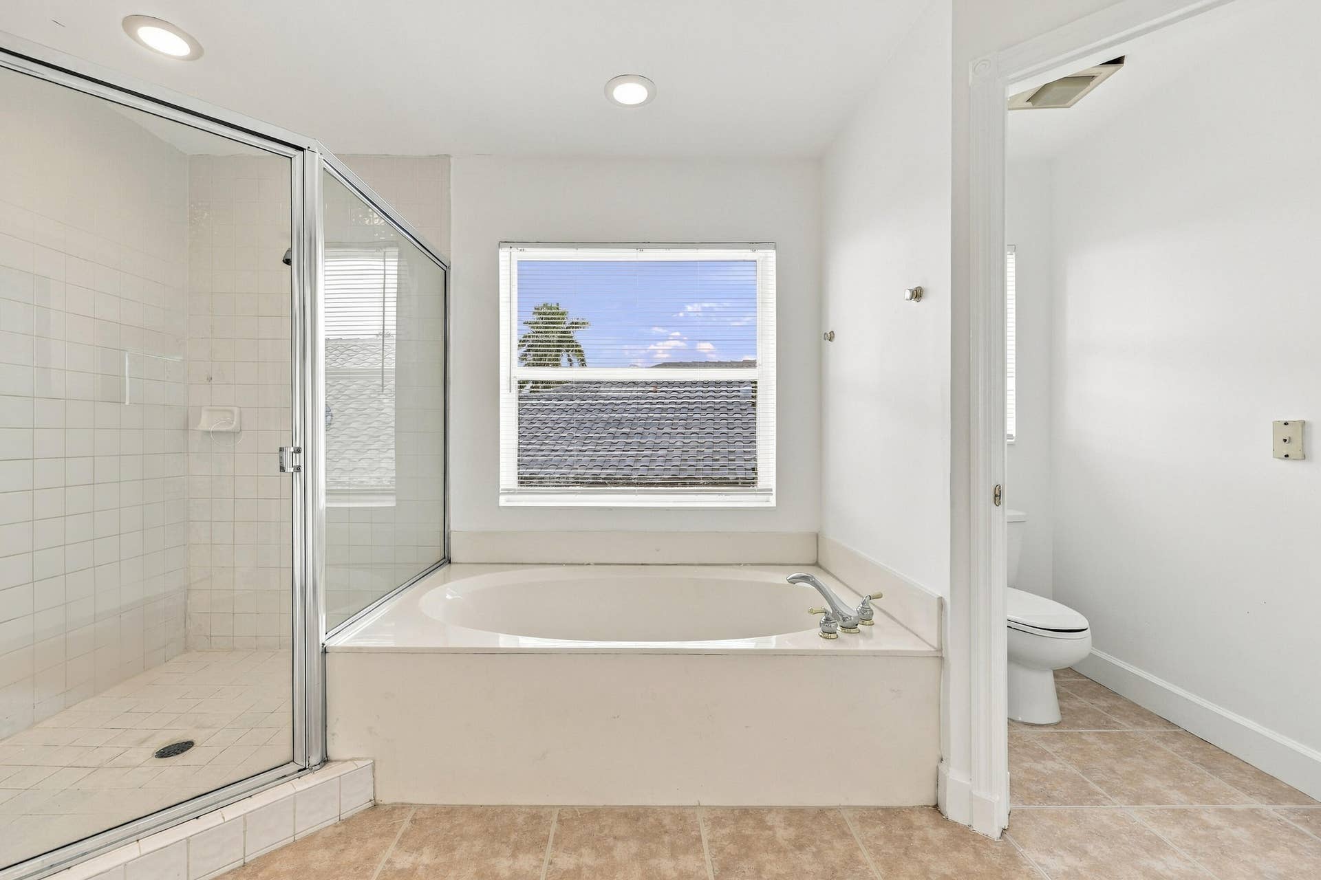 10671 St Thomas Drive, Boca Raton, FL 33498 Enjoy the convenience of a separate soaking tub and oversized glass-enclosed shower, offering the perfect combination of comfort and functionality.