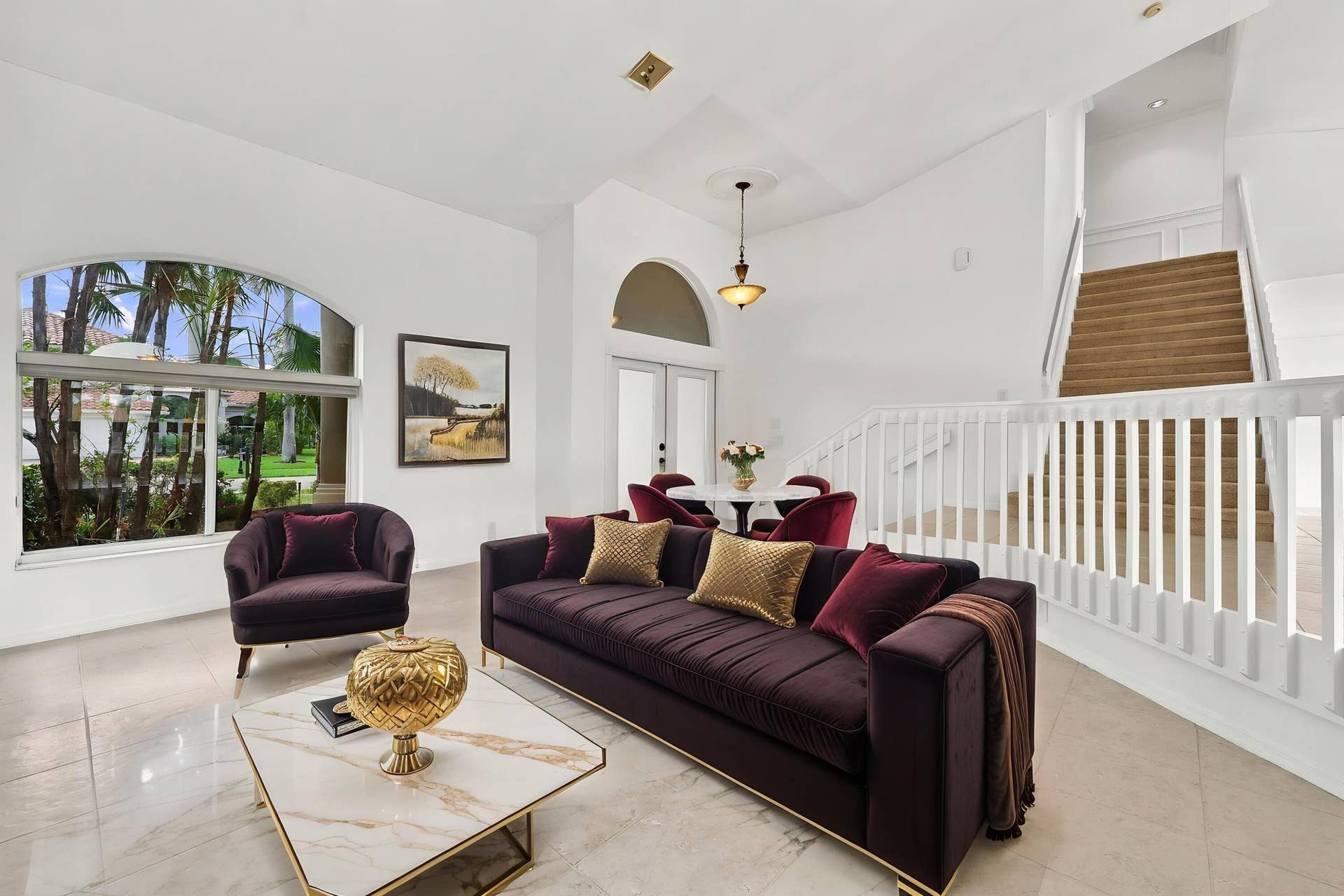 10671 St Thomas Drive, Boca Raton, FL 33498 Impressive formal living room with dramatic vaulted ceilings, oversized arched windows, and an open, airy design that creates a wonderful first impression.