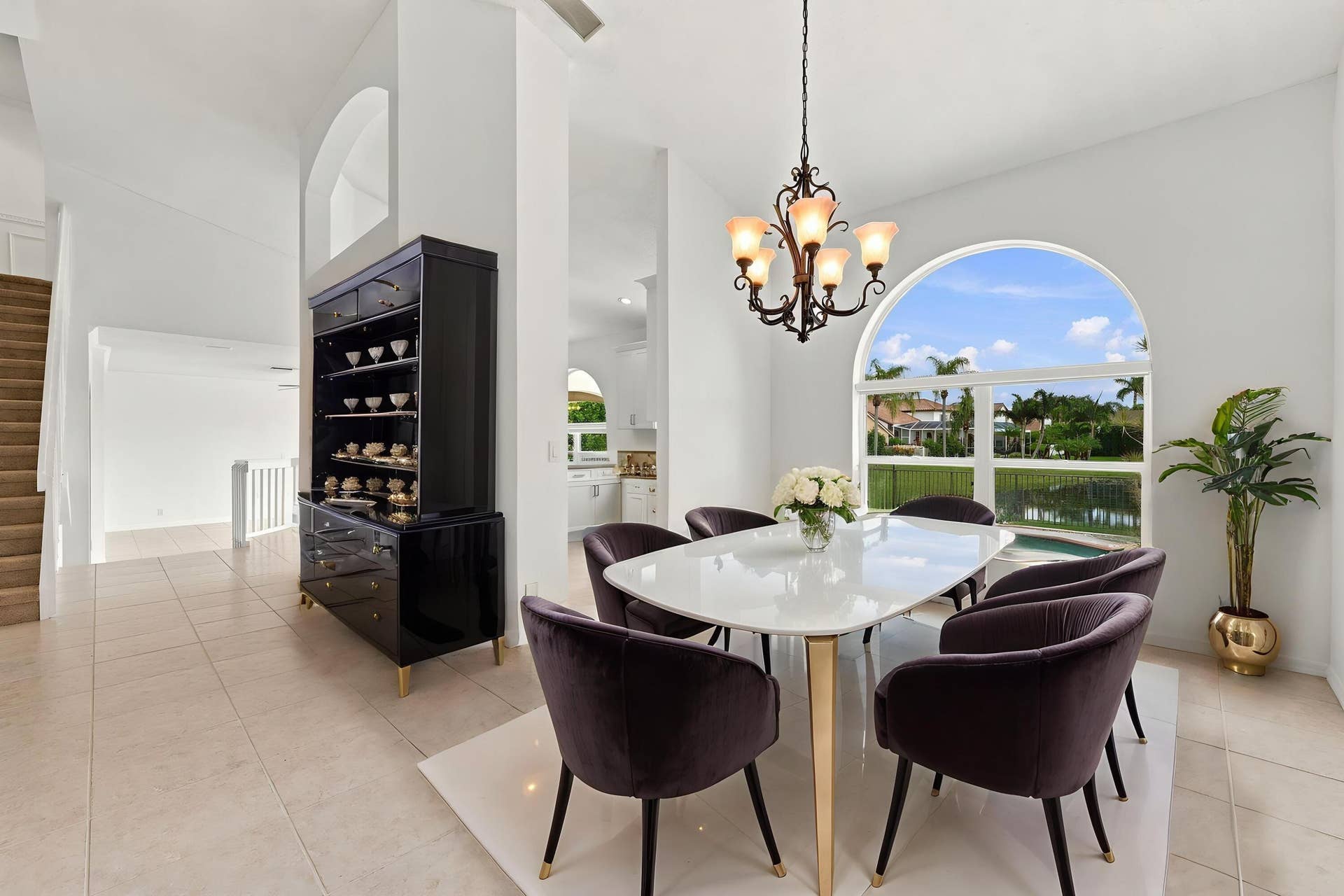 10671 St Thomas Drive, Boca Raton, FL 33498 An elegant chandelier, soaring ceilings, and an open connection to the adjacent living areas create a wonderful setting for entertaining.