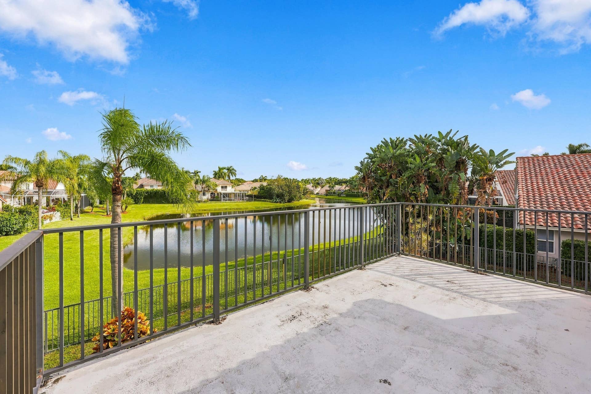 10671 St Thomas Drive, Boca Raton, FL 33498 Breathtaking lake views from your private second-story balcony! The perfect place to enjoy your morning coffee while overlooking the peaceful waterfront and lush tropical surroundings.