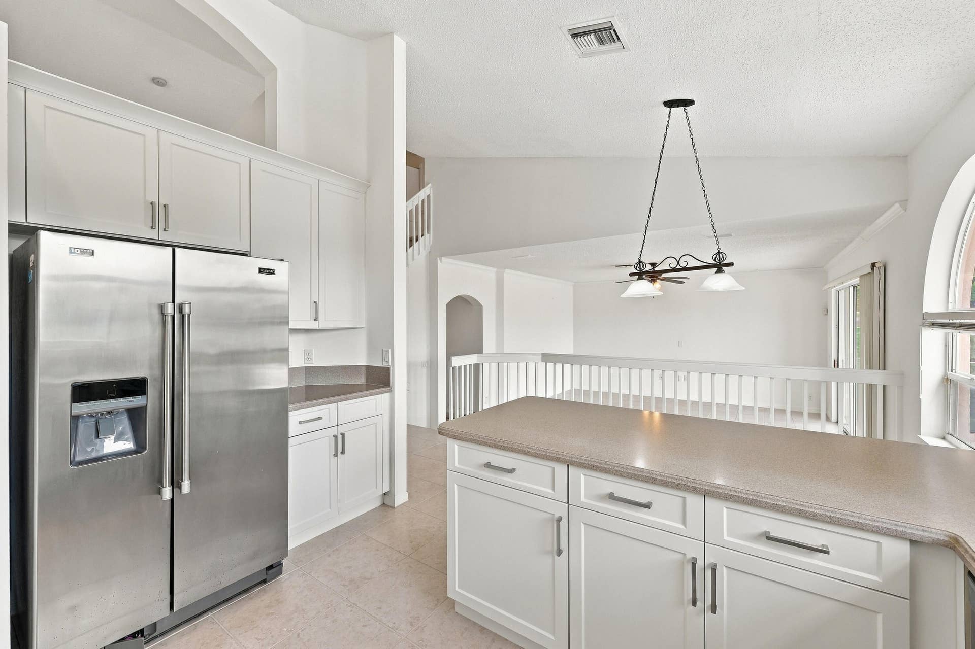 10671 St Thomas Drive, Boca Raton, FL 33498 The kitchen features crisp white cabinetry, stainless steel appliances, ample storage, and a functional layout designed for everyday convenience.