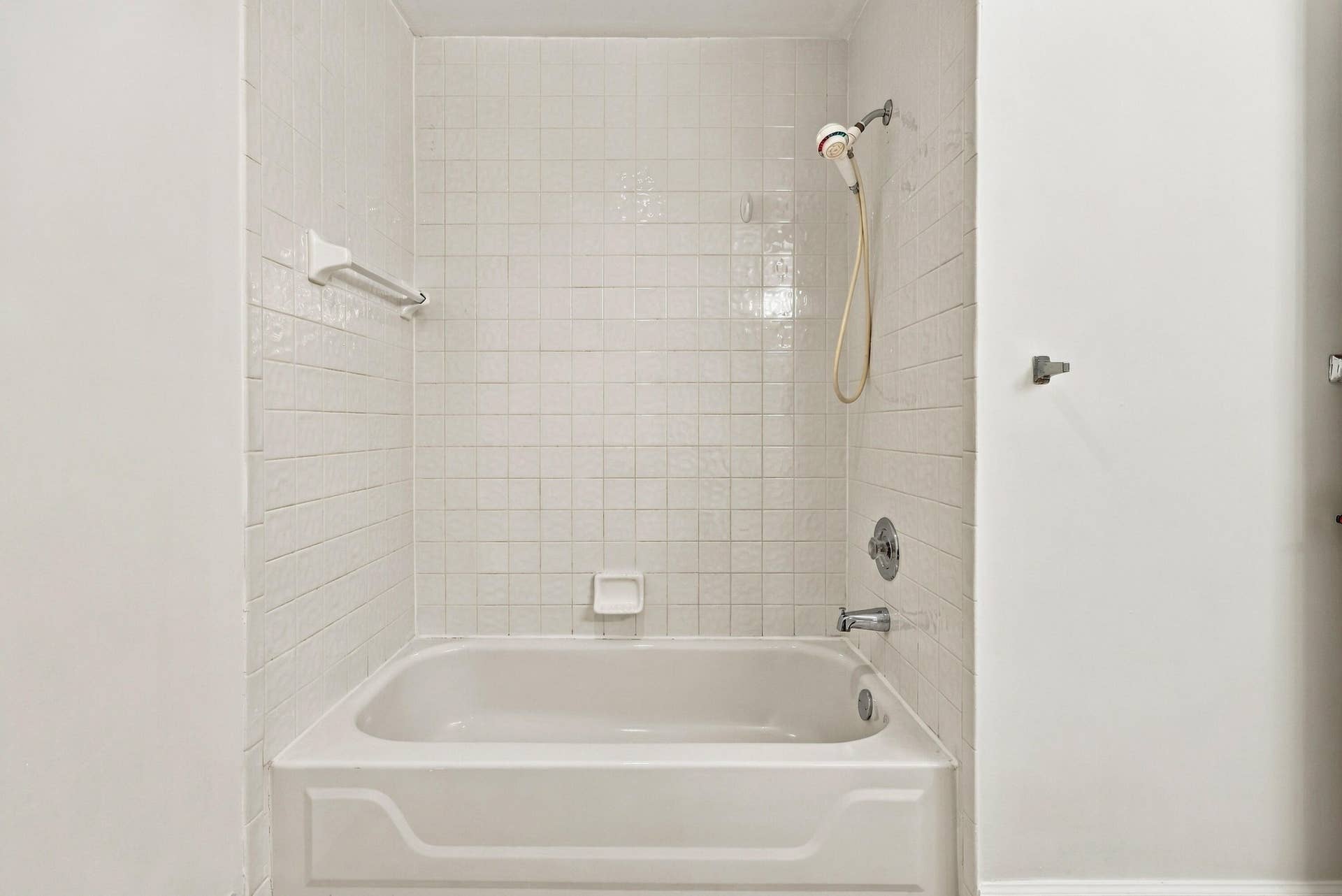 10671 St Thomas Drive, Boca Raton, FL 33498 A convenient tub and shower combination with neutral tile surrounds provides comfort and functionality in this second-floor bathroom, ideally situated near the guest bedrooms.