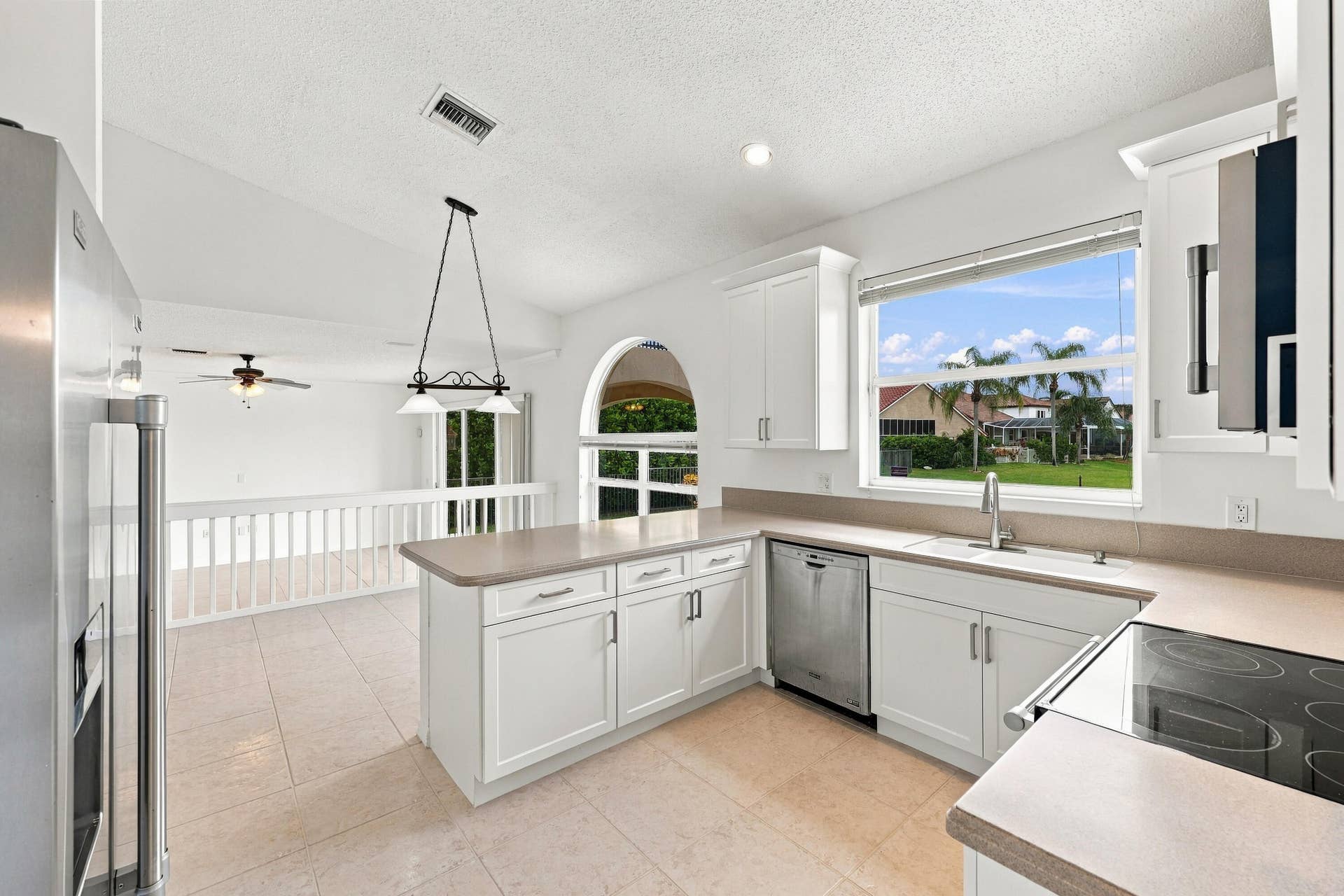 10671 St Thomas Drive, Boca Raton, FL 33498 An expansive breakfast bar provides additional seating and preparation space, while the kitchen's open design allows for effortless interaction with the adjacent breakfast nook.