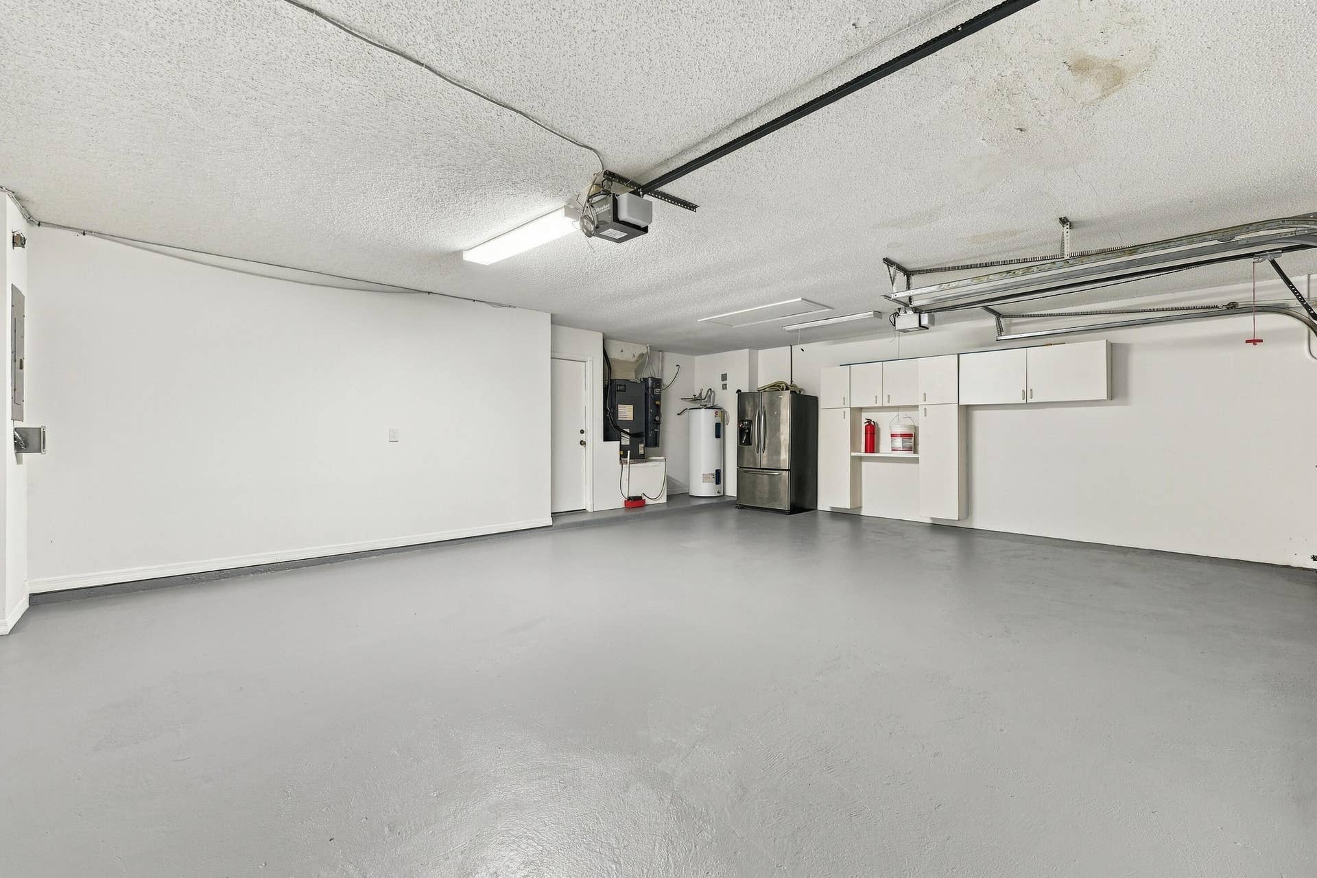 10671 St Thomas Drive, Boca Raton, FL 33498 This oversized three-car garage features a finished floor, utility sink, and ample room for vehicles, recreational equipment, additional storage, or a dedicated workshop area.
