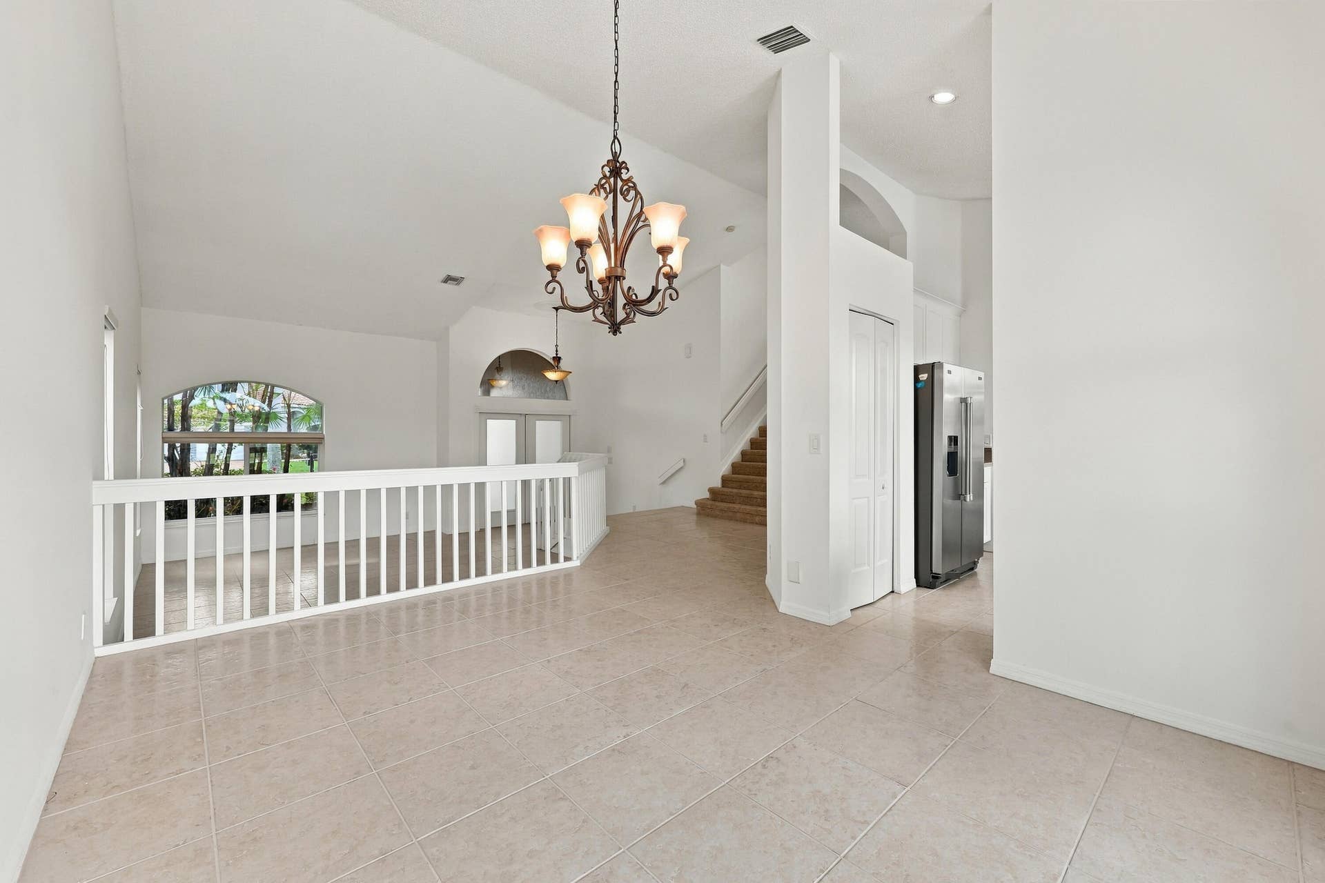 10671 St Thomas Drive, Boca Raton, FL 33498 The formal dining room features impressive ceiling heights, decorative lighting, and an open design that adds to the home's spacious character
