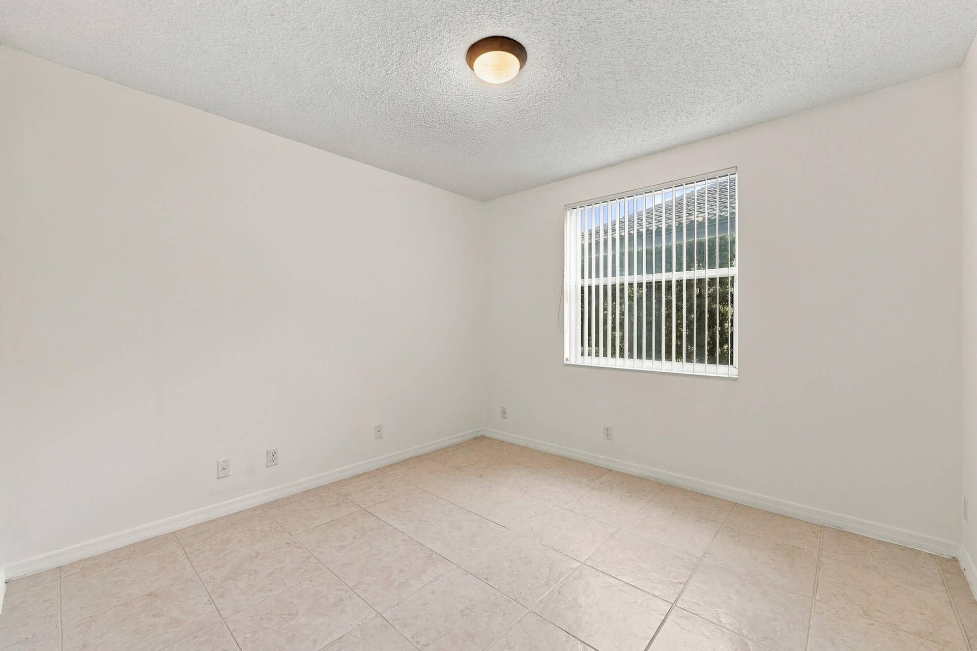 10671 St Thomas Drive, Boca Raton, FL 33498 This well-appointed main-level bedroom offers flexibility for guests, a private office, or additional living space, with convenient access to the home's main living areas.