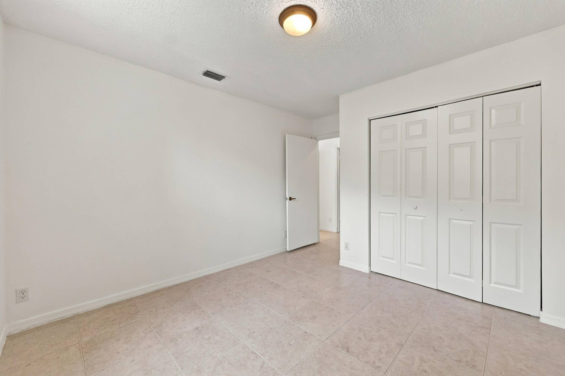 10671 St Thomas Drive, Boca Raton, FL 33498 A versatile main-level bedroom offering generous closet space, neutral finishes, and a practical layout ideal for guests or a home office.