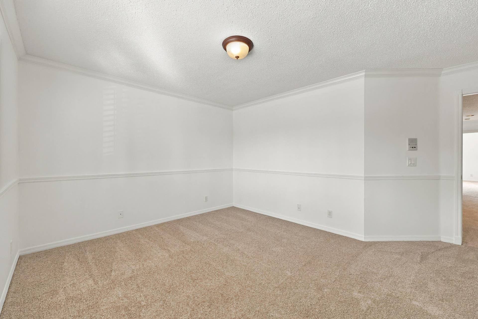 10671 St Thomas Drive, Boca Raton, FL 33498 With its generous proportions, neutral carpeting, and decorative wall details, this bedroom offers flexibility for guests, family, or a home office.