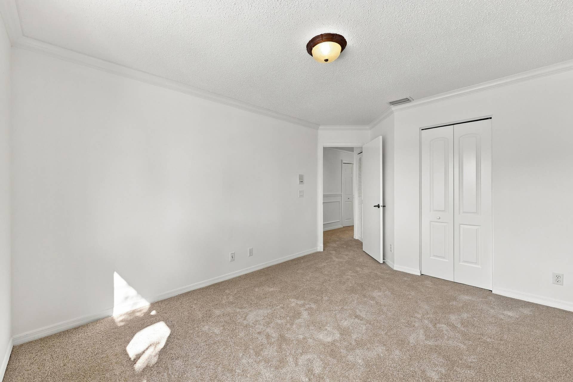 10671 St Thomas Drive, Boca Raton, FL 33498 Generous proportions, soft carpeting, and a spacious closet make this bedroom ideal for guests, family members, or a home office.