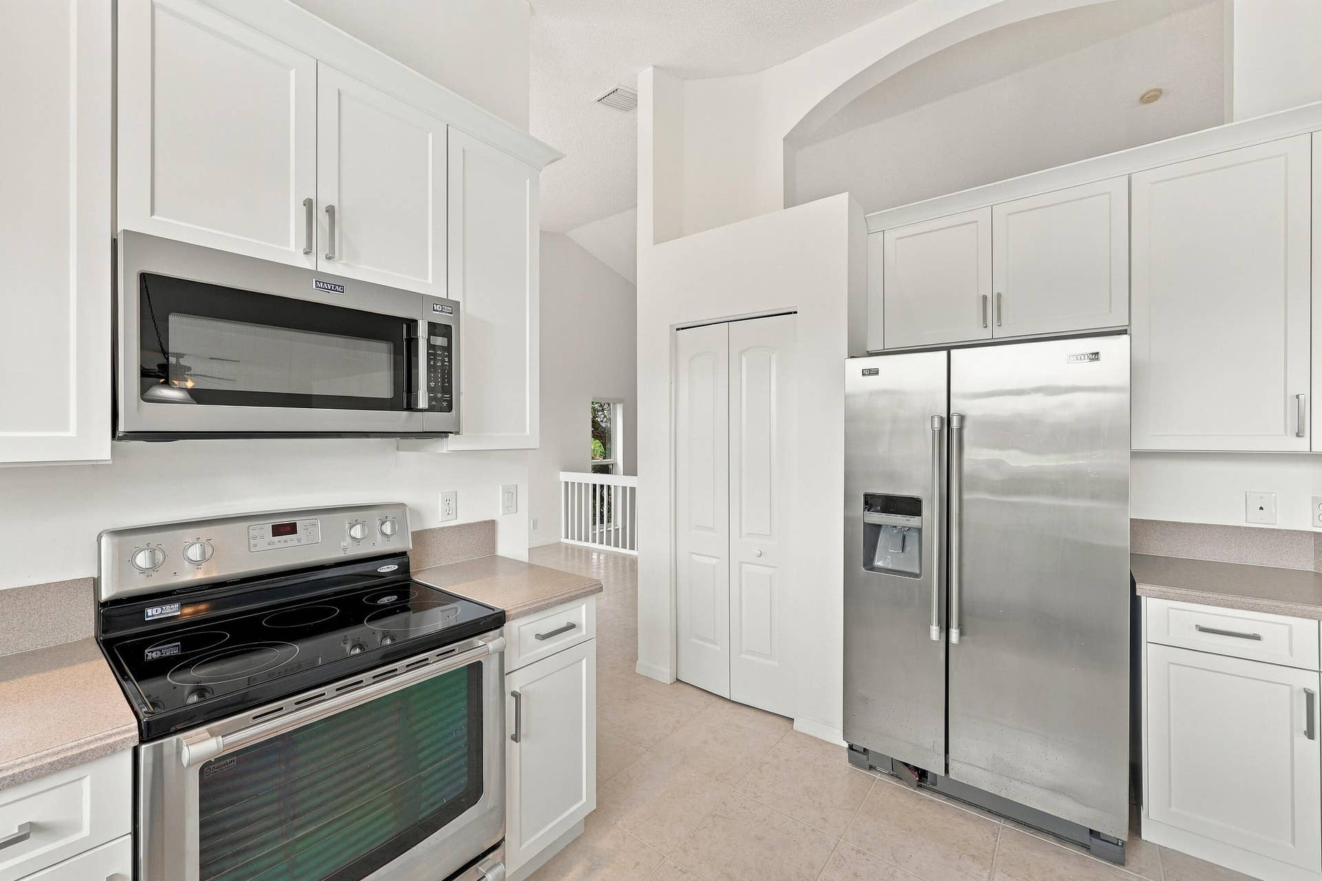 10671 St Thomas Drive, Boca Raton, FL 33498 The kitchen features crisp white cabinetry, stainless steel appliances, ample storage, and a functional layout designed for everyday convenience.