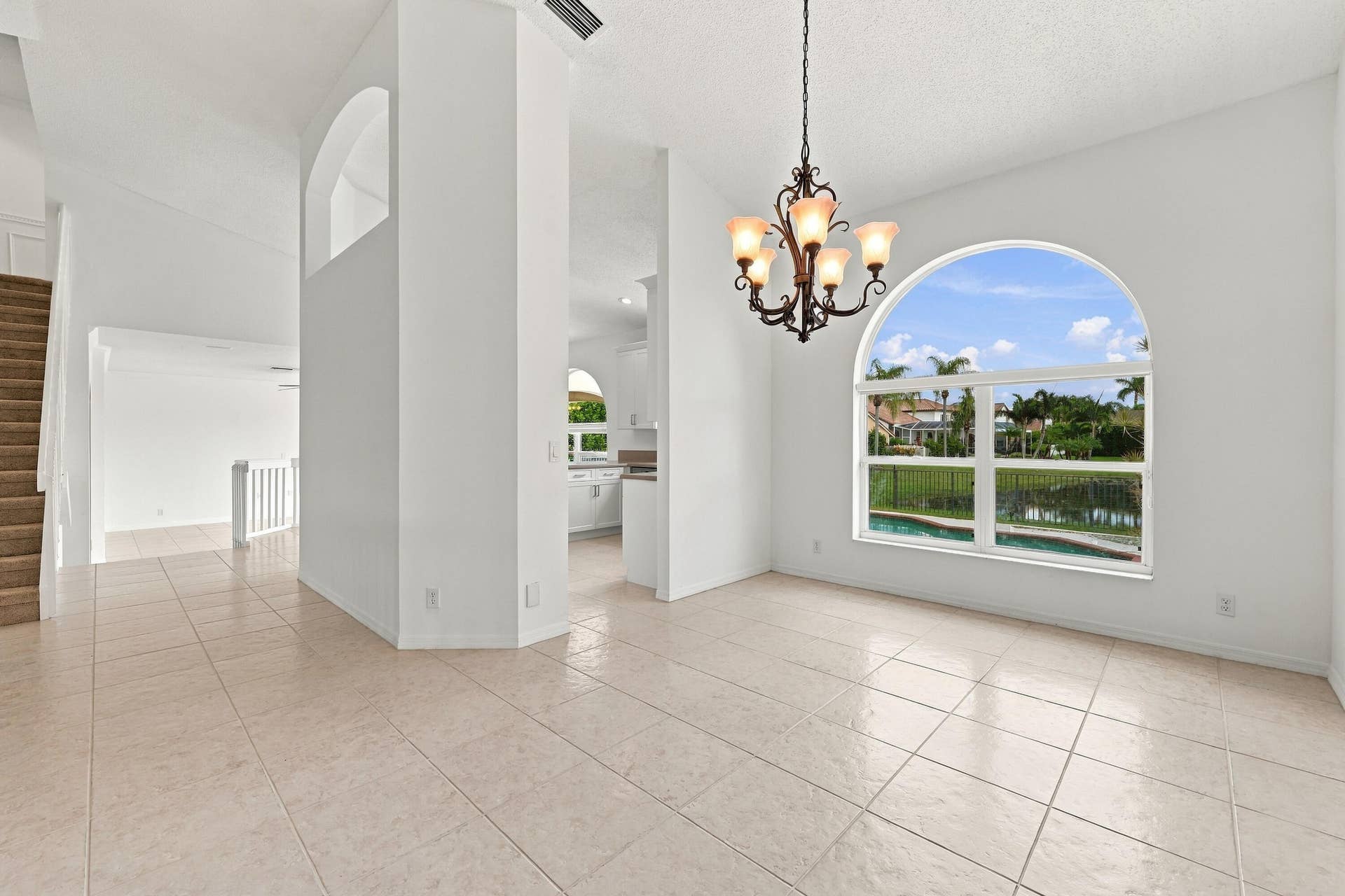 10671 St Thomas Drive, Boca Raton, FL 33498 An elegant chandelier, soaring ceilings, and an open connection to the adjacent living areas create a wonderful setting for entertaining.