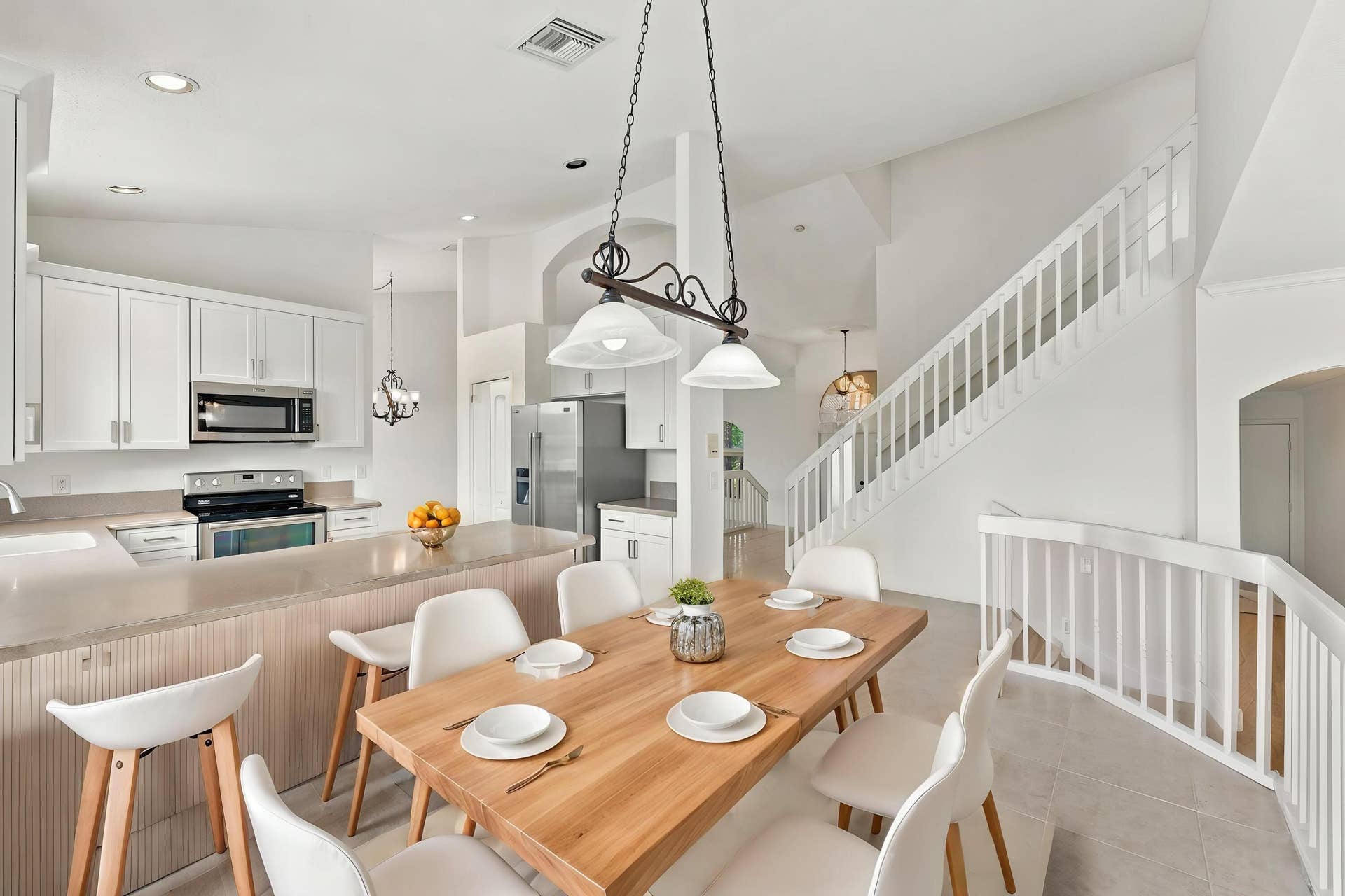 10671 St Thomas Drive, Boca Raton, FL 33498 An inviting kitchen and breakfast area featuring white cabinetry, generous counter space, and an open design that connects seamlessly to the surrounding living areas.