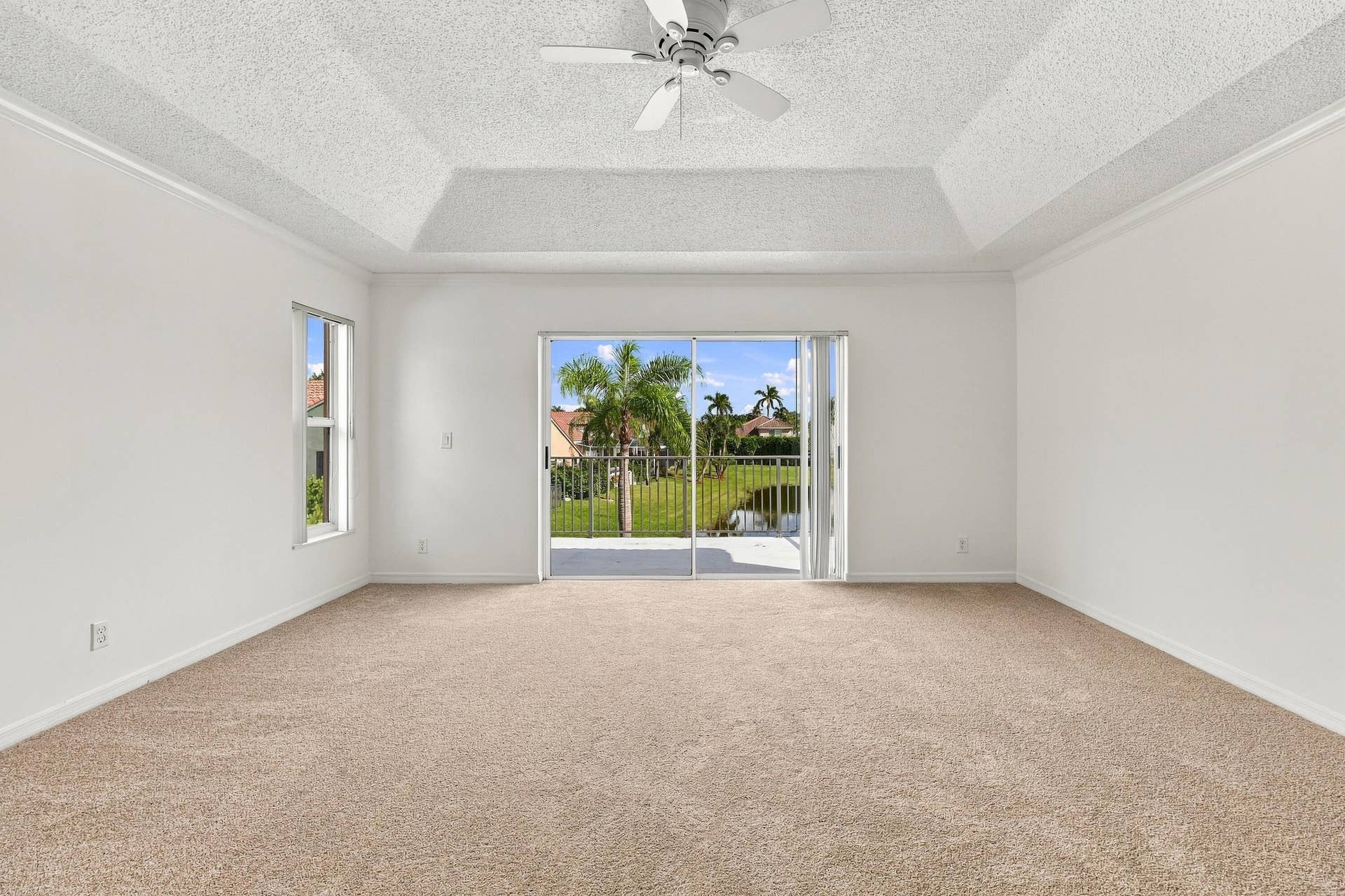10671 St Thomas Drive, Boca Raton, FL 33498 Wake up to beautiful waterfront views! Sliding glass doors open directly onto a private second-story balcony overlooking the tranquil lake and tropical surroundings.