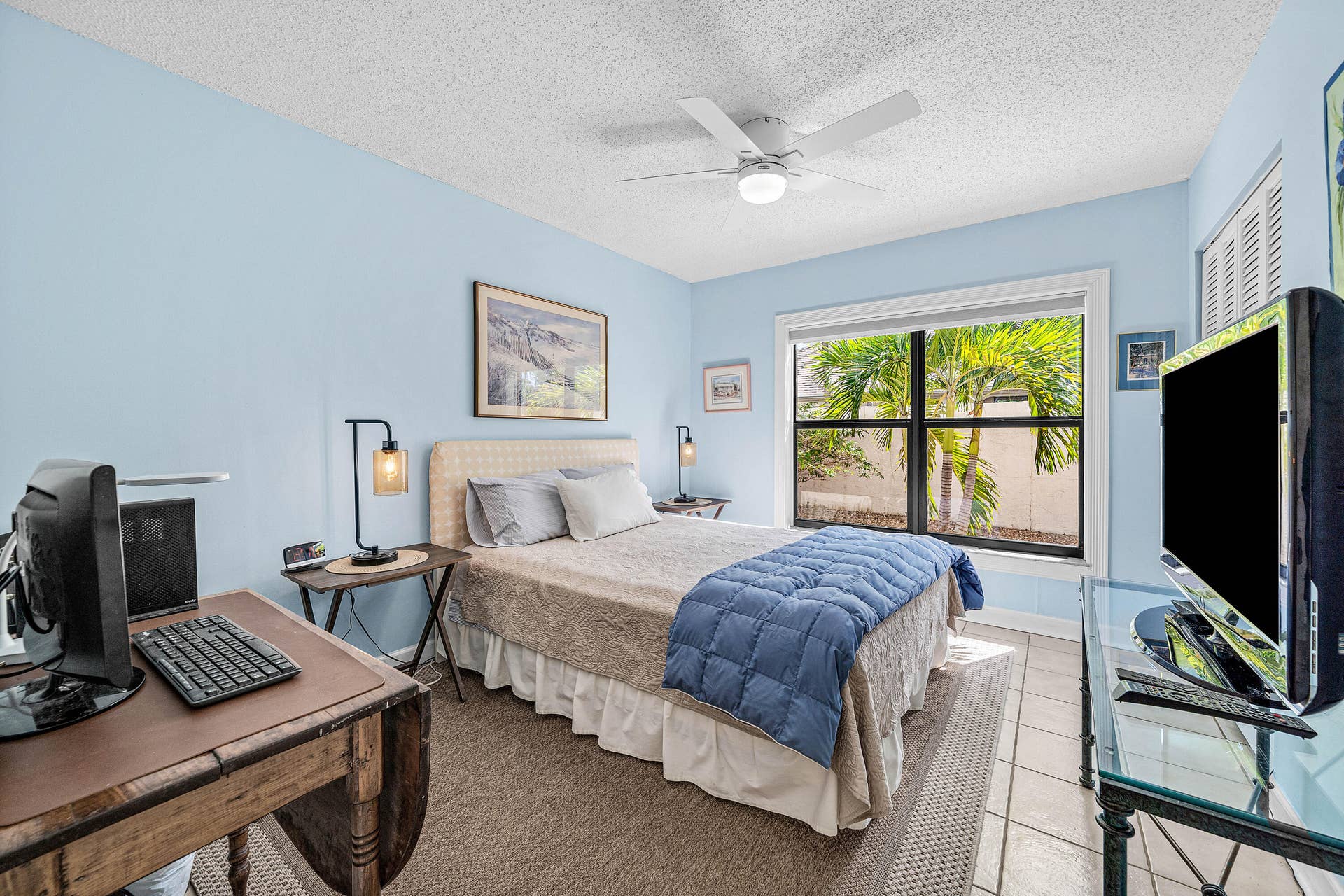 503 SW 29TH Avenue, Delray Beach, FL 33445 Room featuring tile flooring, a dual-pane window with black framing, and an integrated ceiling fan with light fixture