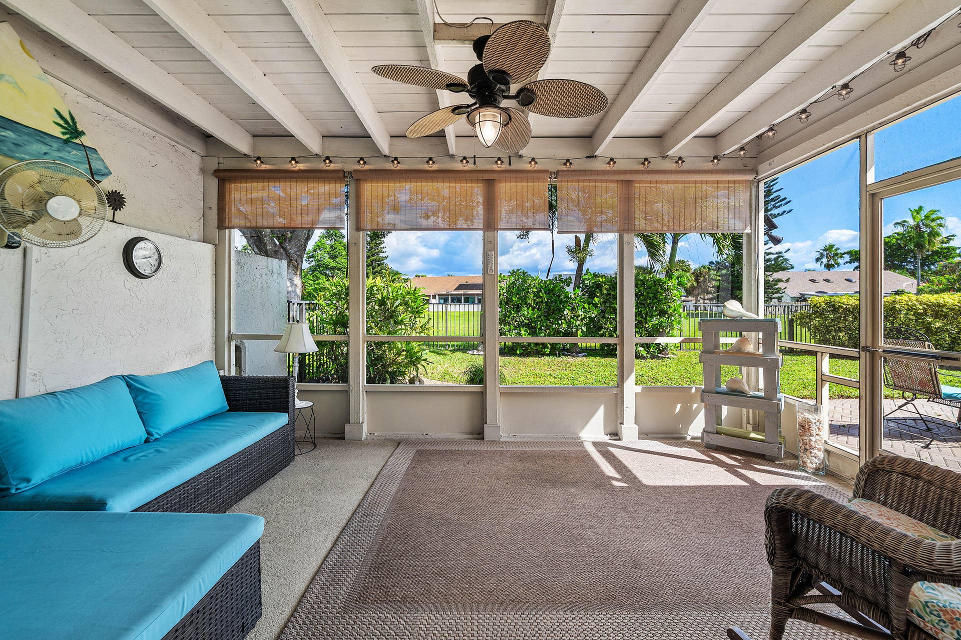 503 SW 29TH Avenue, Delray Beach, FL 33445 Enclosed patio featuring a painted exposed-beam ceiling, ceiling fan with integrated lighting, concrete flooring, and screen-wall construction
