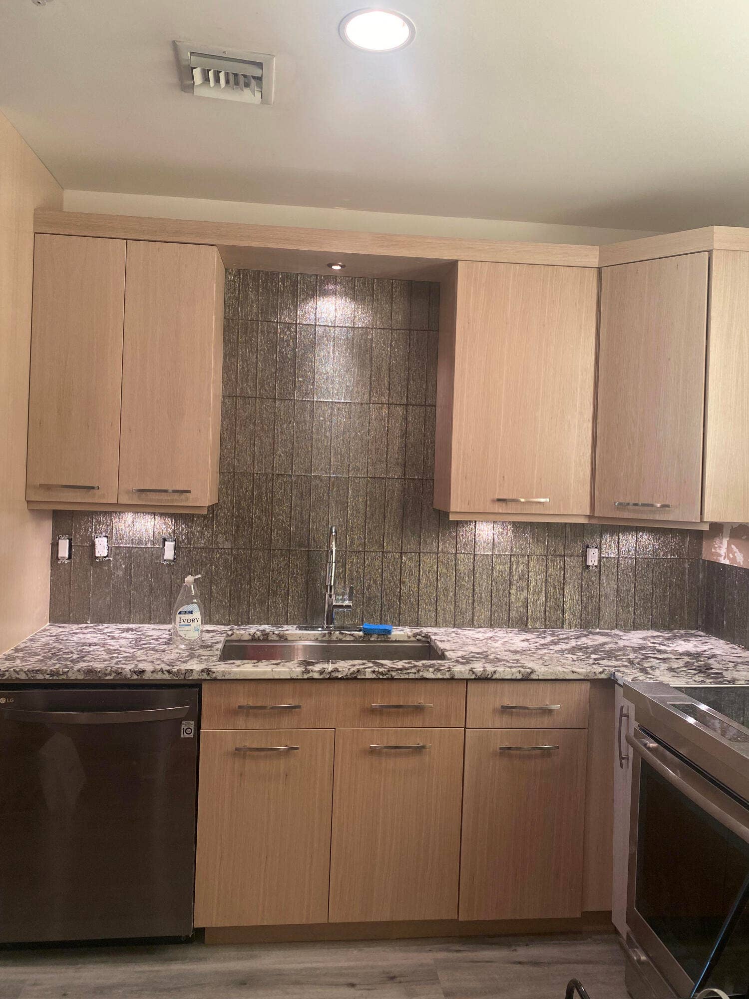 Kitchen with plenty of lighting for work areas.