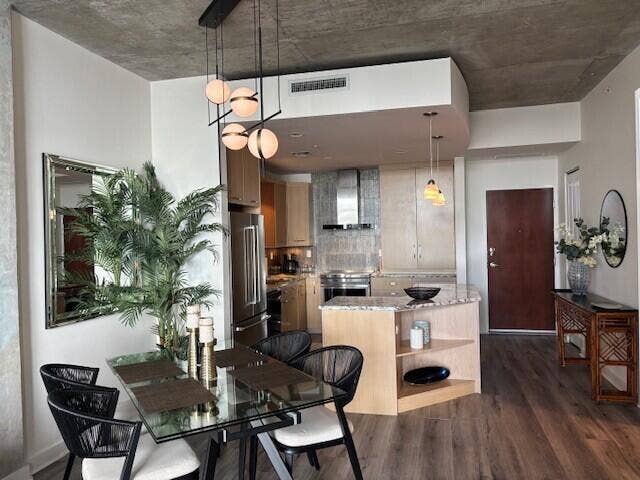 From Living Room to Dining with chandelier and to Kitchen with island providing storage and prep area.