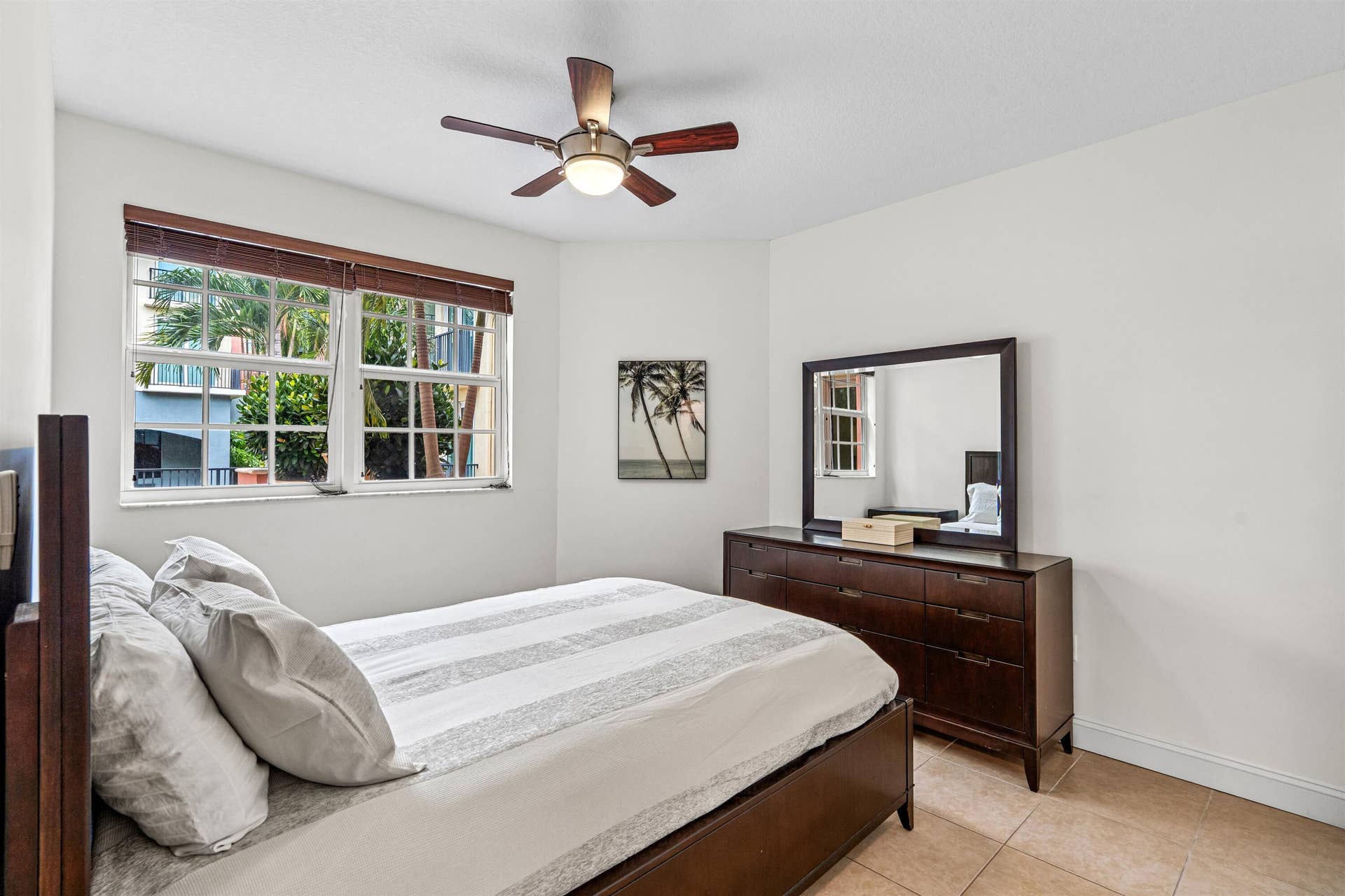 Multi-pane windows with integrated blinds, tile flooring, and a central ceiling fan with integrated lighting