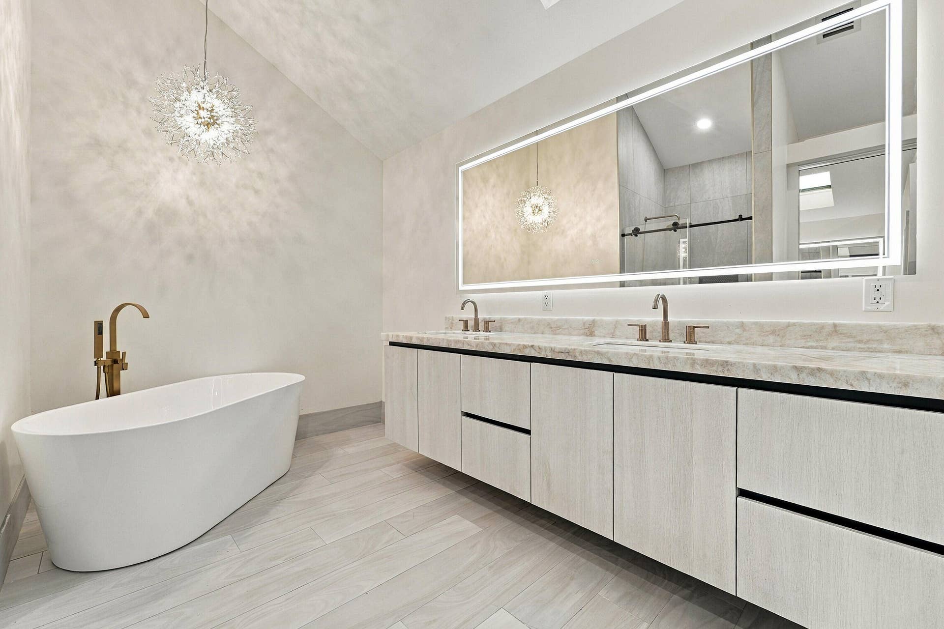 2398 SARATOGA BAY Drive, West Palm Beach, FL 33409 Gorgeous primary bathroom with free standing soaking tub and crystallo quartzite countertops