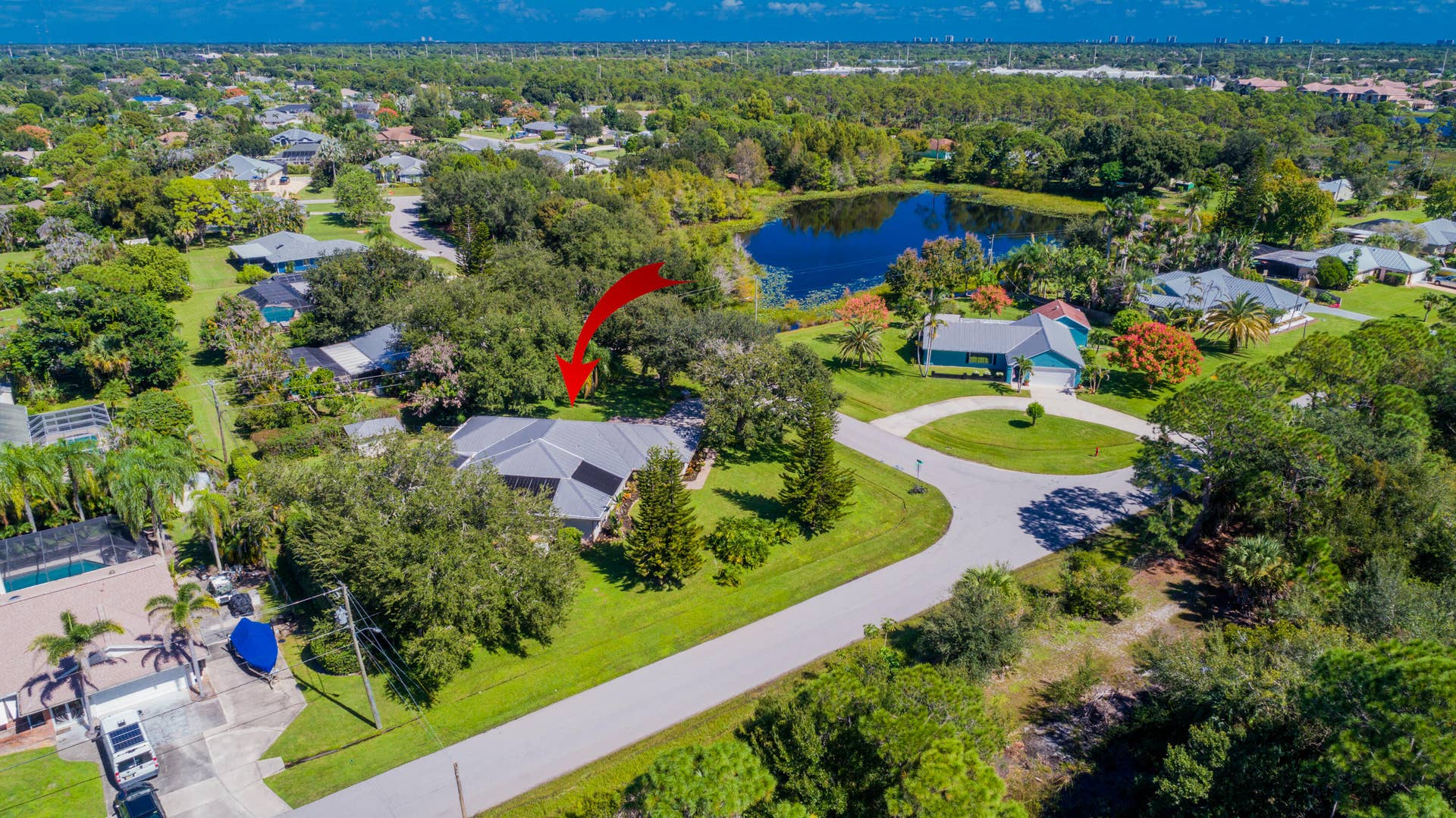 3098 SE BUR Street, Port St Lucie, FL 34952 A bird's-eye view of this beautifully landscaped .49-acre property in Sandpiper Bay! Enjoy mature trees, a fully fenced yard, a screened pool, and the privacy of a generously sized lot with no HOA.