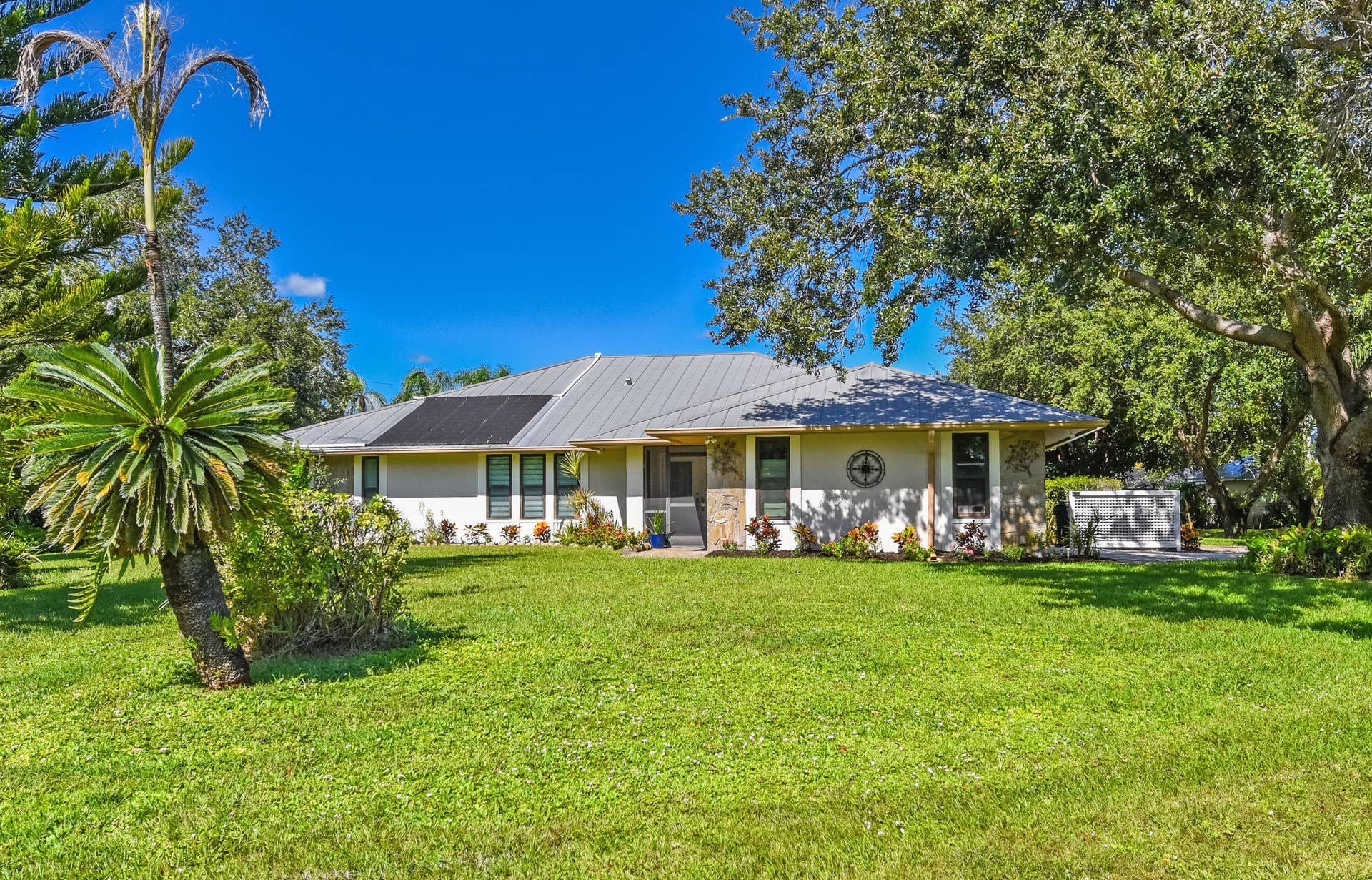 3098 SE BUR Street, Port St Lucie, FL 34952 Enjoy the beauty of Sandpiper Bay! This inviting home sits on a beautifully landscaped .49-acre lot with mature trees, a lush green lawn, and plenty of room to enjoy the outdoors. No HOA!