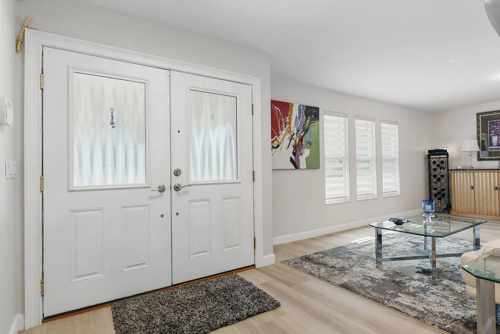 3098 SE BUR Street, Port St Lucie, FL 34952 double entry doors with decorative glass panels open to a bright, inviting living room
