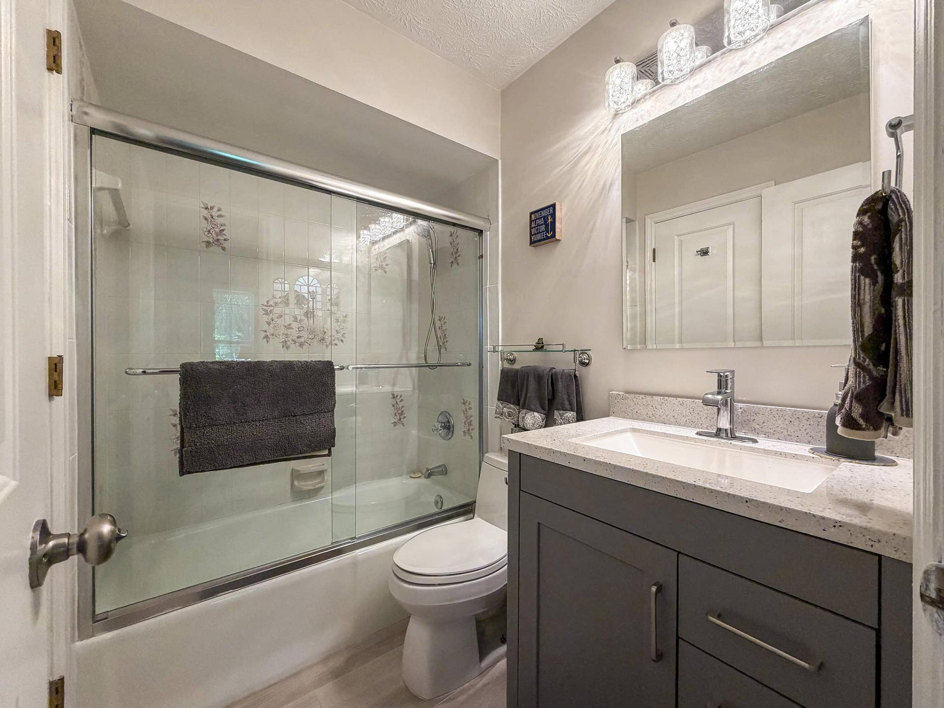 3098 SE BUR Street, Port St Lucie, FL 34952 Bathroom 3 is conveniently located next to Bedroom 4 and features a tub/shower combination, updated vanity, and modern finishes.