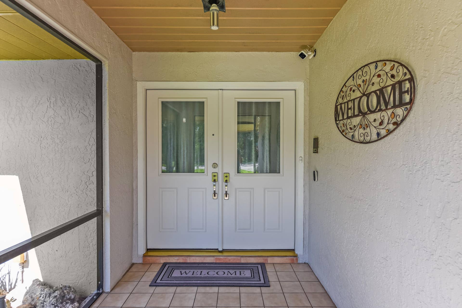 3098 SE BUR Street, Port St Lucie, FL 34952 An inviting covered entry with elegant double doors welcomes you home.