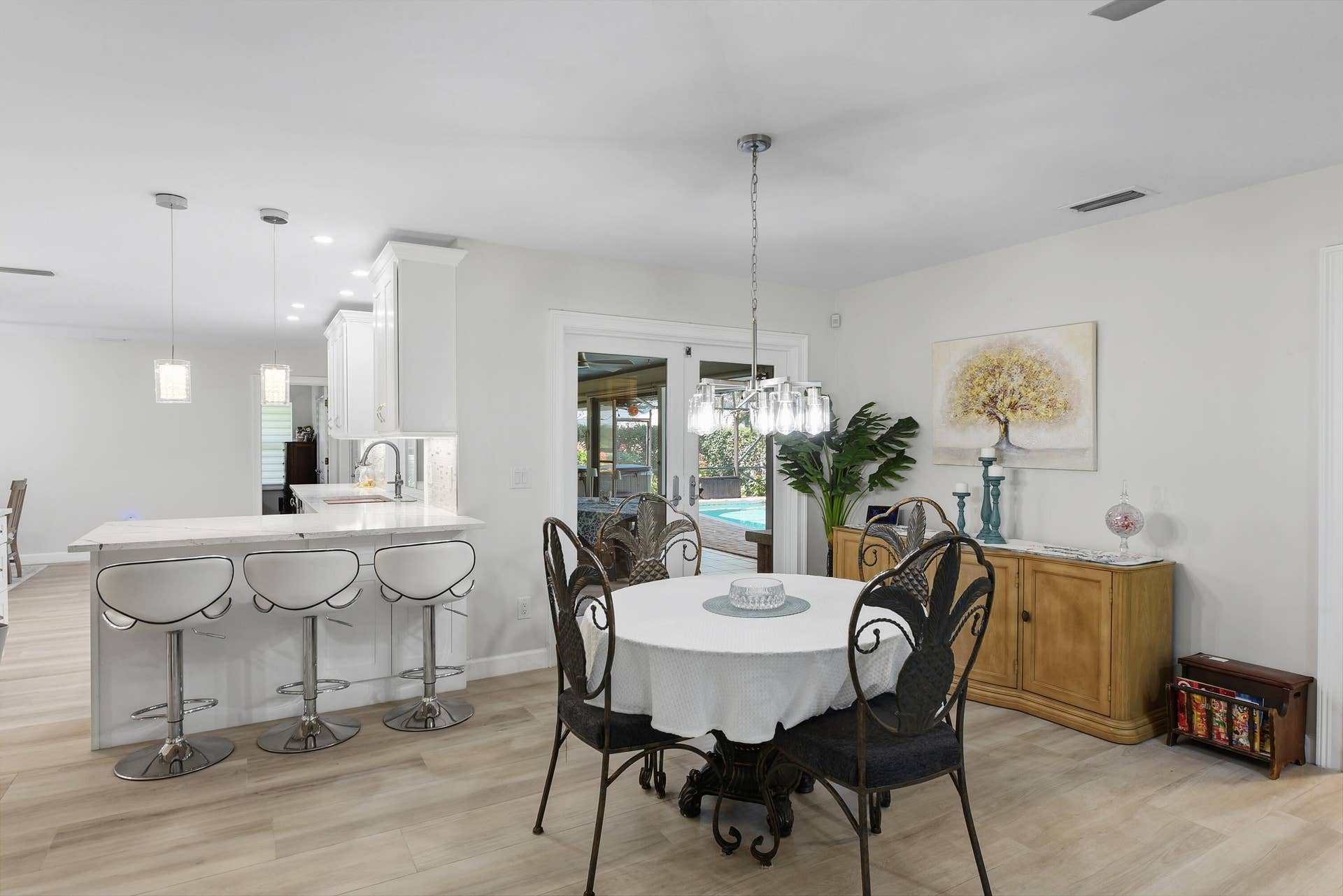 3098 SE BUR Street, Port St Lucie, FL 34952 Bright and inviting breakfast area overlooking the screened pool and lanai! Conveniently located beside the beautifully remodeled kitchen with breakfast bar seating, creating the perfect setting for casual dining and entertaining.