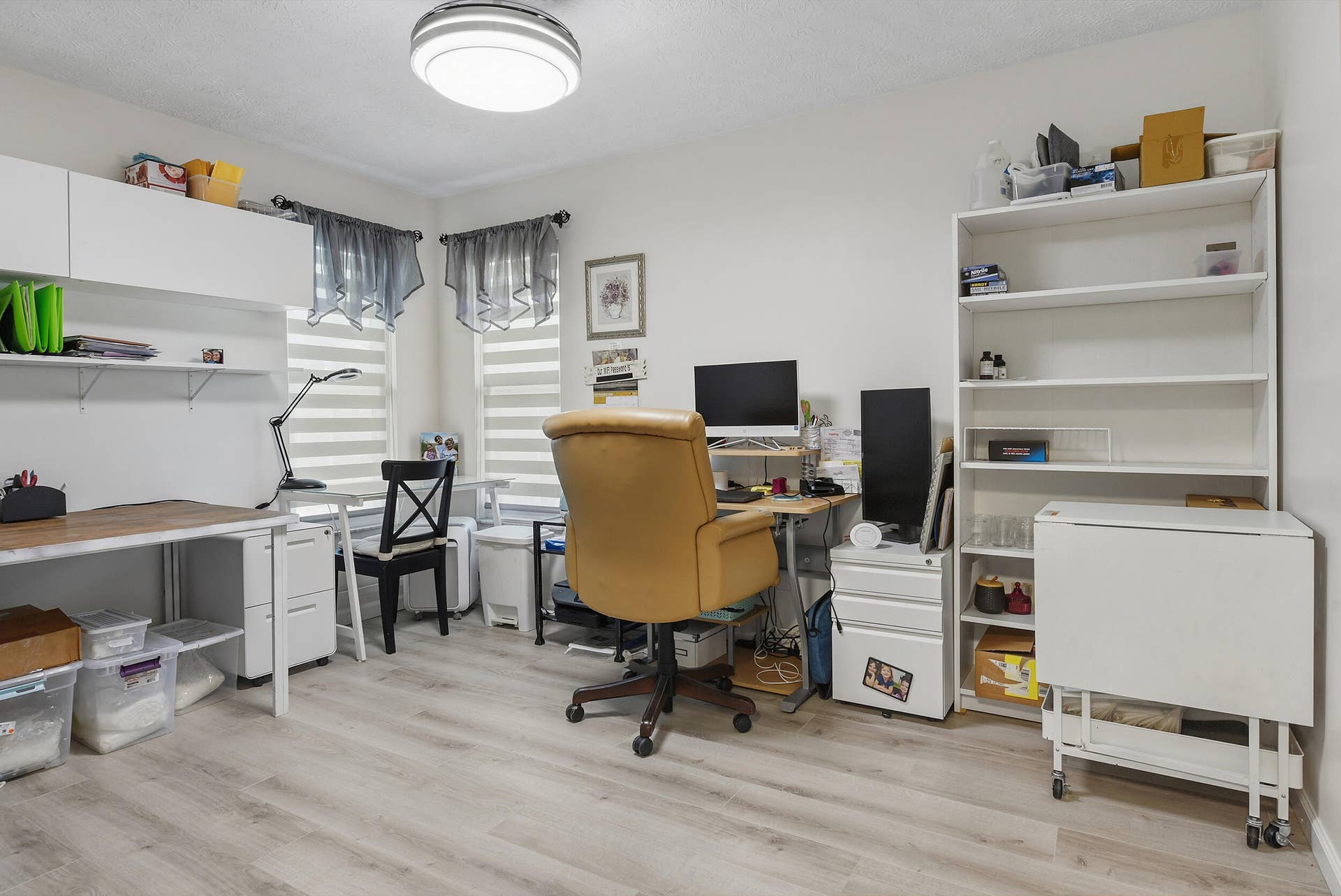 3098 SE BUR Street, Port St Lucie, FL 34952 Flexible living space currently used as a home office, featuring attractive flooring, built-in storage, and natural light. Easily suited for a bedroom, hobby room, or private workspace!