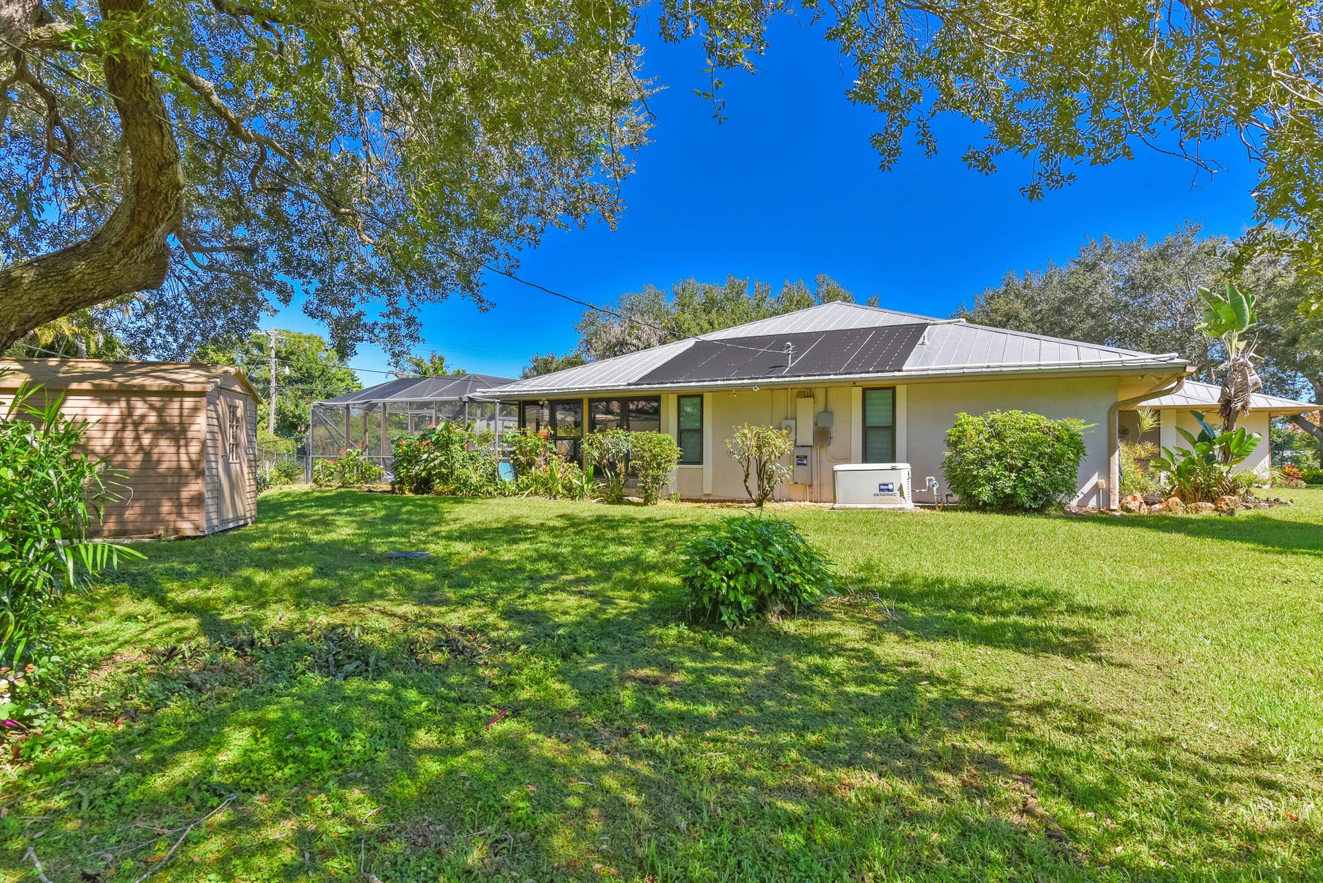 3098 SE BUR Street, Port St Lucie, FL 34952 Enjoy the expansive backyard and screened pool area featuring a solar heated saltwater pool, perfect for year-round enjoyment, entertaining, and relaxed Florida living.
