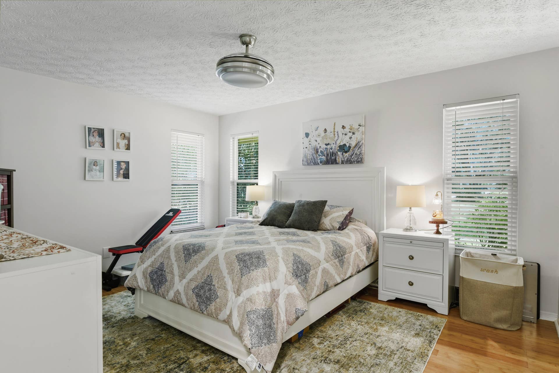 3098 SE BUR Street, Port St Lucie, FL 34952 Bedroom 3 offers beautiful flooring, abundant natural light, stylish window treatments, and a new ceiling fan. A welcoming and comfortable retreat!