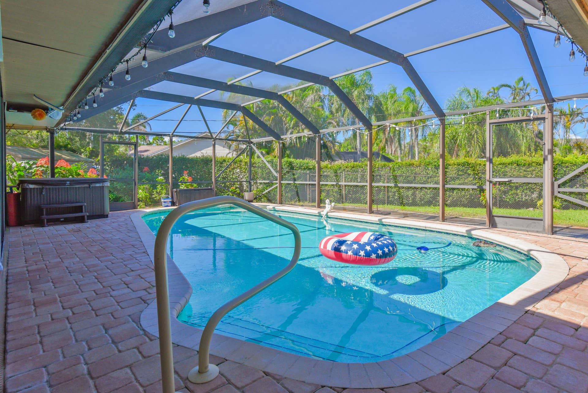 3098 SE BUR Street, Port St Lucie, FL 34952 Dive into Florida living! Enjoy the pool, relaxing spa, and screened enclosure surrounded by lush tropical landscaping