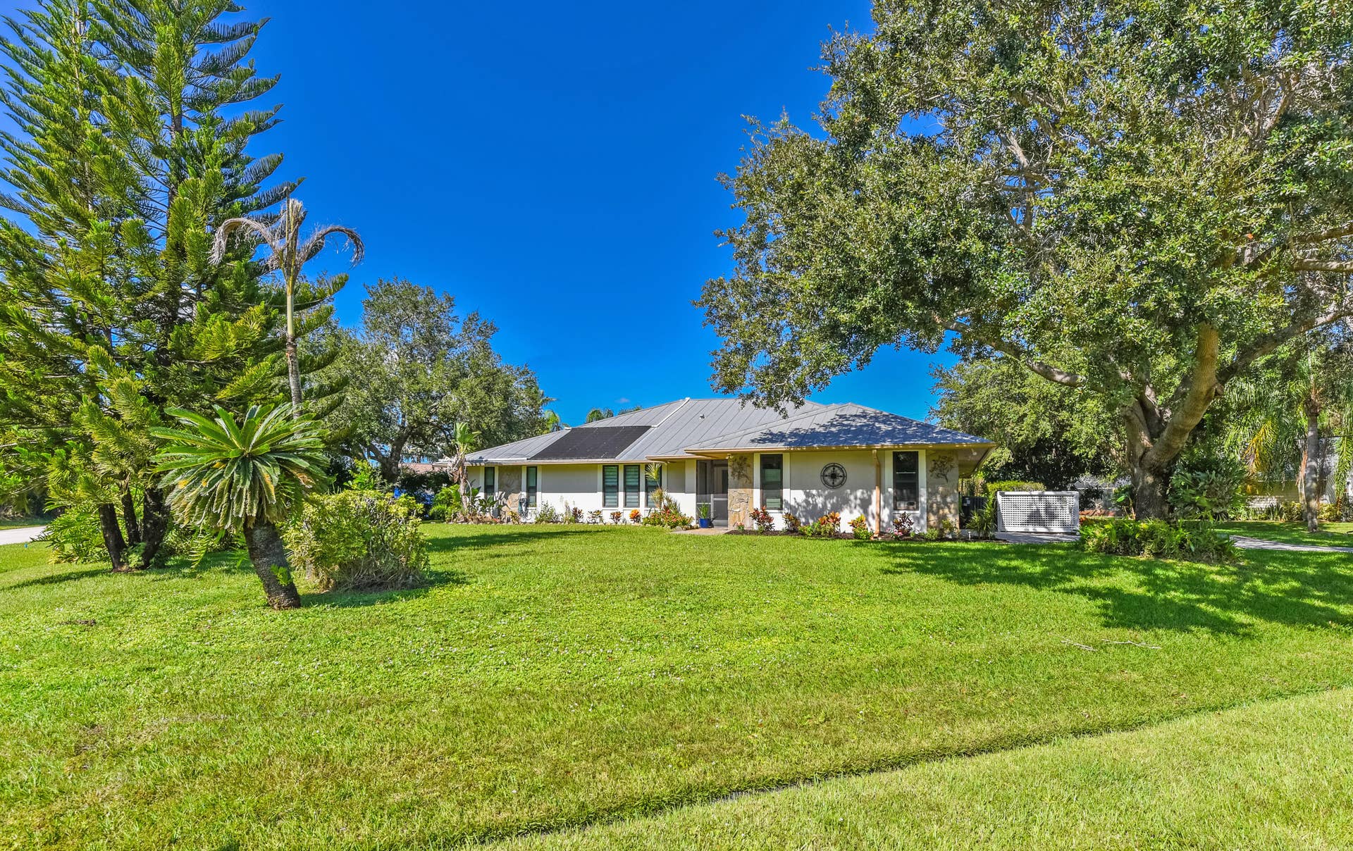 3098 SE BUR Street, Port St Lucie, FL 34952 Situated on a desirable .49-acre corner lot, this home features majestic shade trees, lush landscaping, and a beautiful green lawn. Plenty of room to enjoy Florida living with NO HOA!