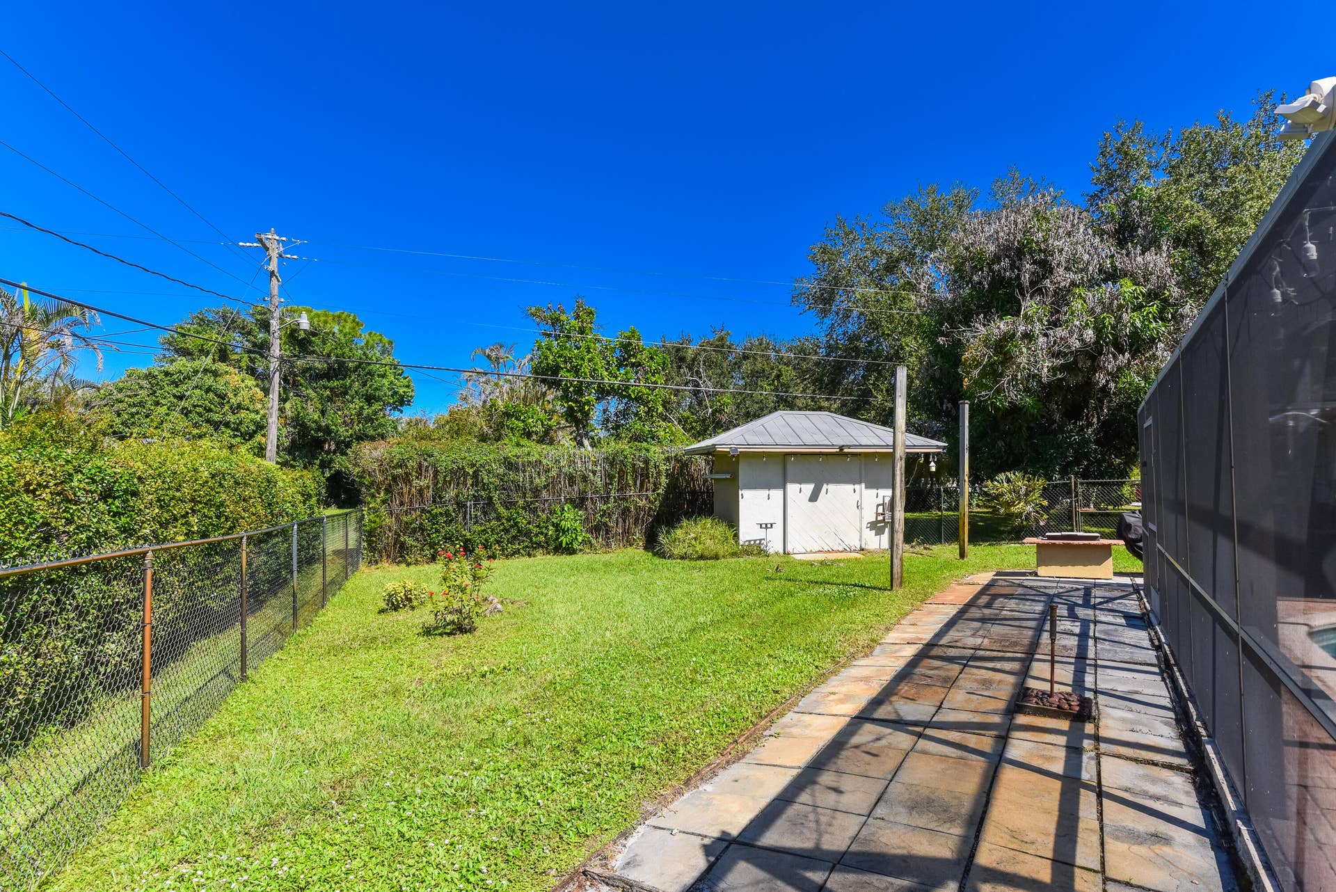 3098 SE BUR Street, Port St Lucie, FL 34952 There's more yard beyond the hedges! Enjoy a fully fenced .49-acre property with a generous lawn, mature landscaping, and plenty of room for outdoor activities.