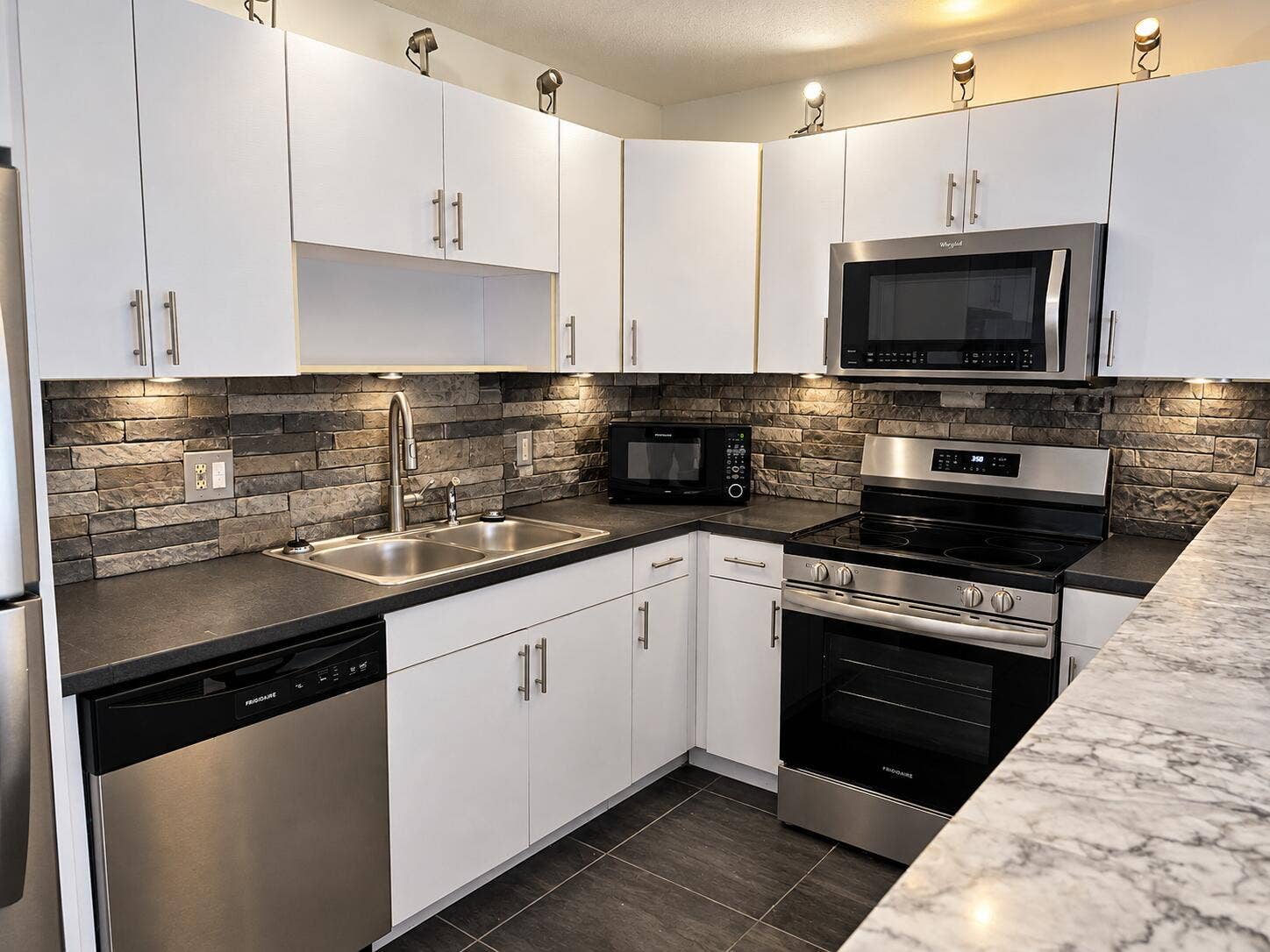 Modern White Kitchen with Stone Backspla