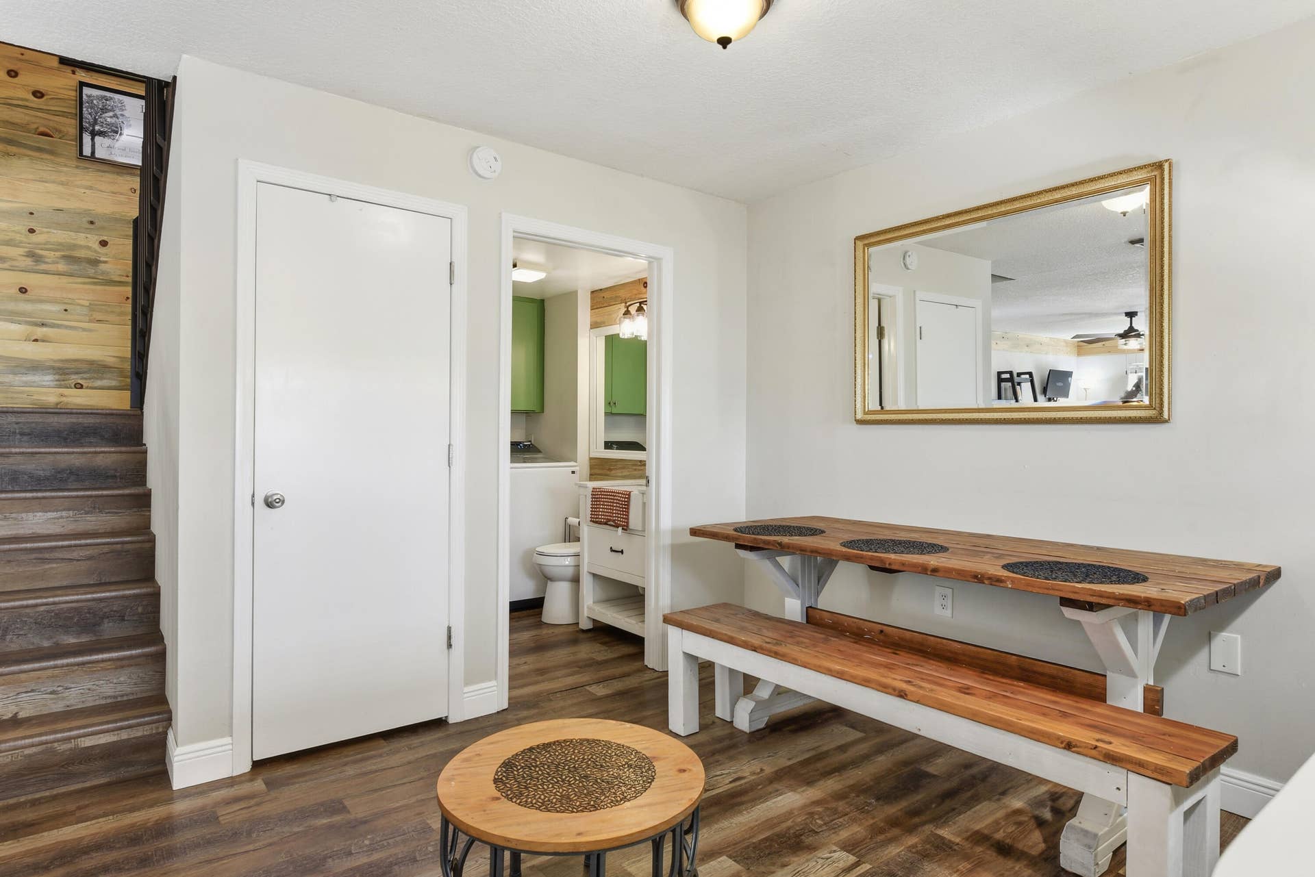 3233 SW SUNSET TRACE Circle, Palm City, FL 34990 Wood-finish flooring, staircase with natural wood accent wall, and ceiling-mounted light fixture